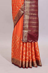 Bright orange jaal pattern with small floral motifs art mysore silk saree with contrast border and blouse