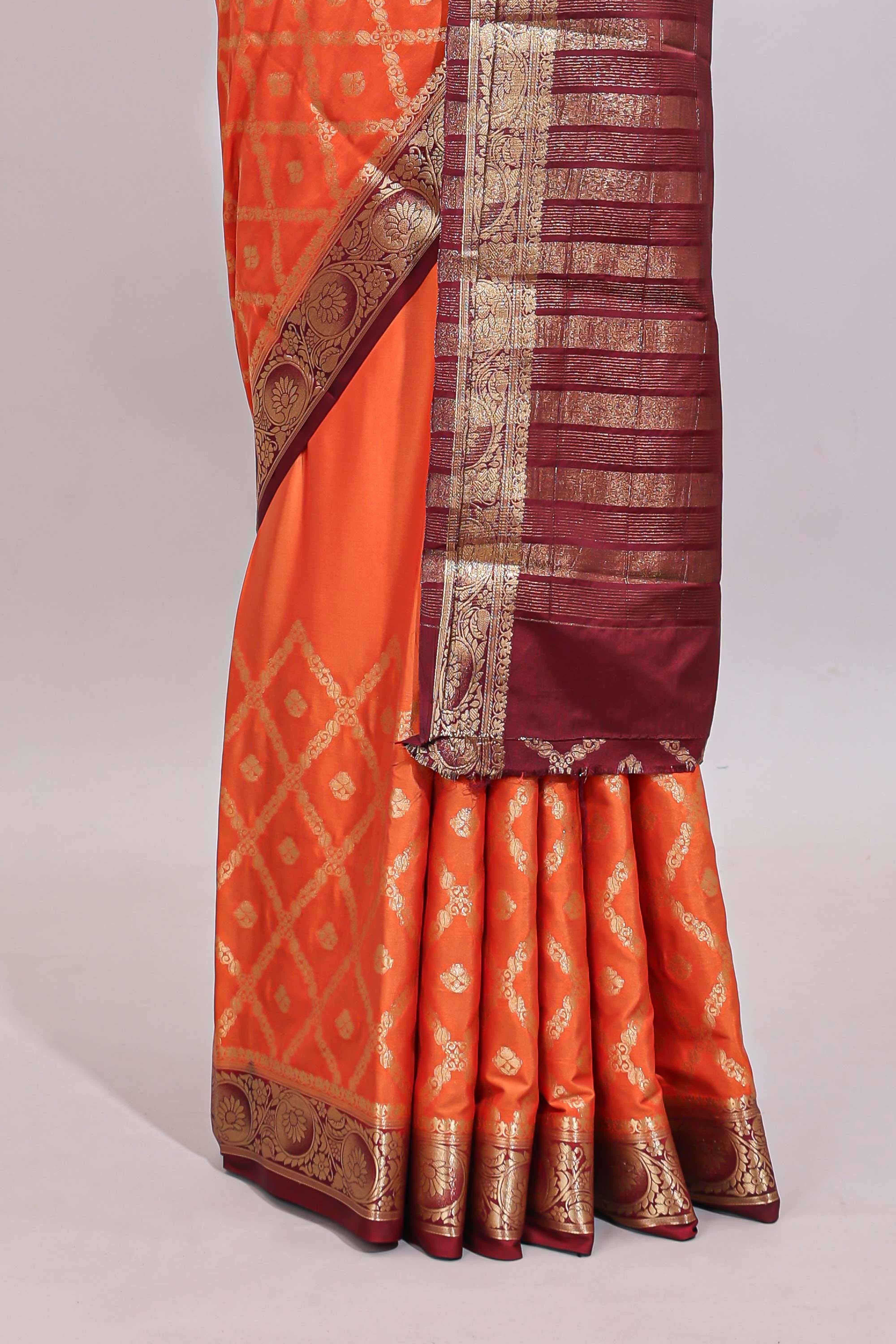 Bright orange jaal pattern with small floral motifs art mysore silk saree with contrast border and blouse
