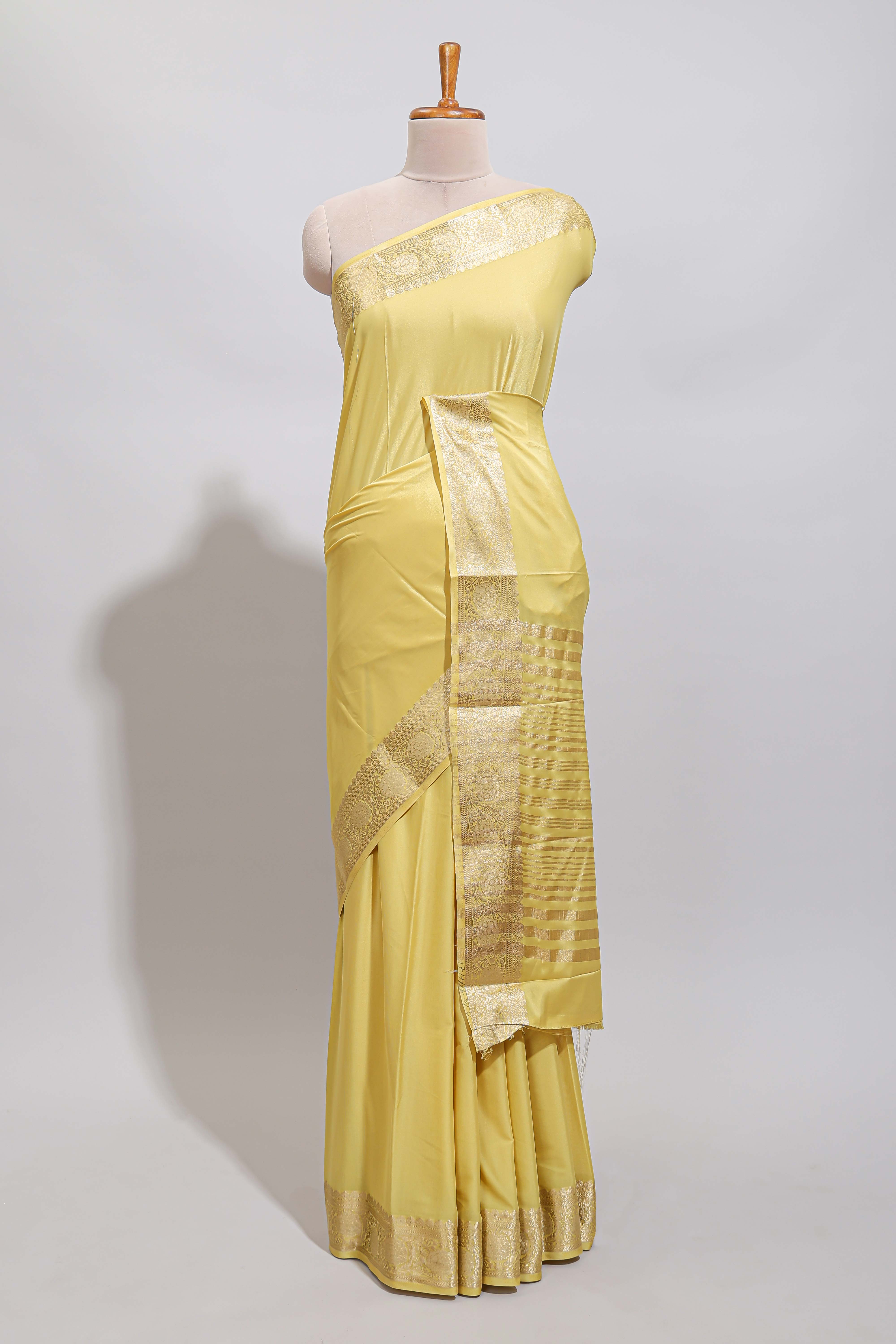 Pale yellow plain design art mysore silk saree with self zari border and matching blouse