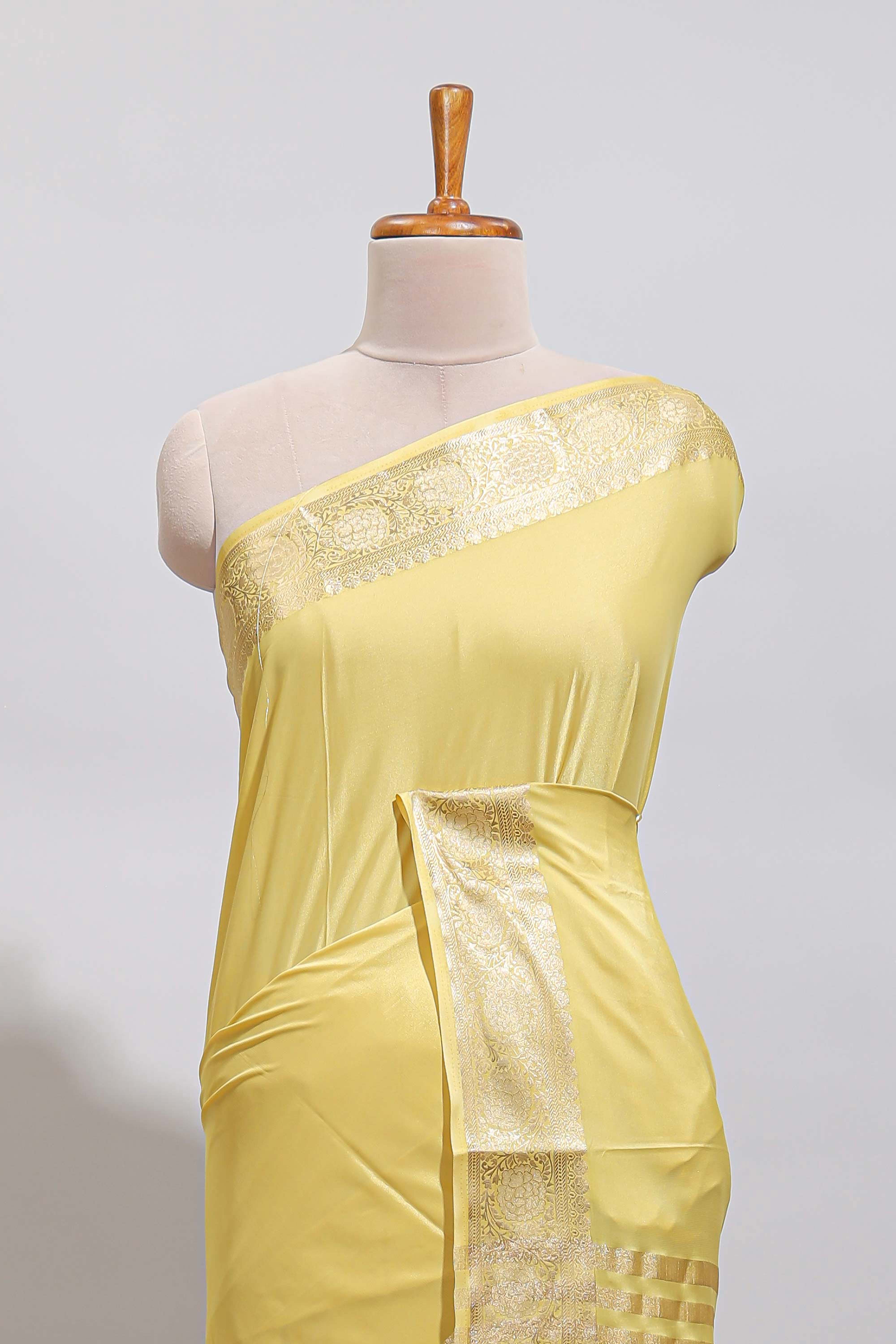 Pale yellow plain design art mysore silk saree with self zari border and matching blouse