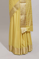 Pale yellow plain design art mysore silk saree with self zari border and matching blouse