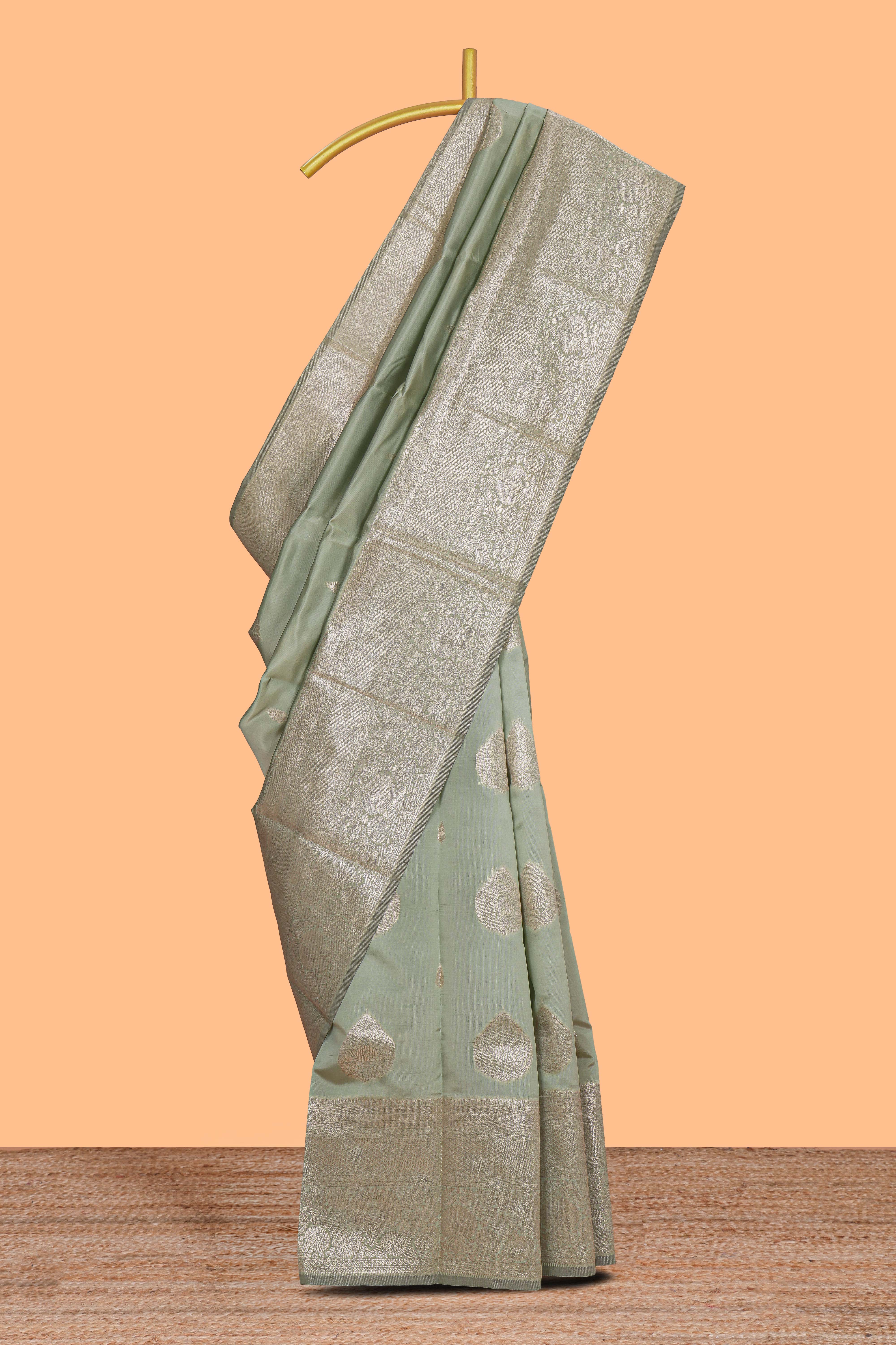 Pista green zari floral motifs art silk saree with self zari border and matching motifs blouse