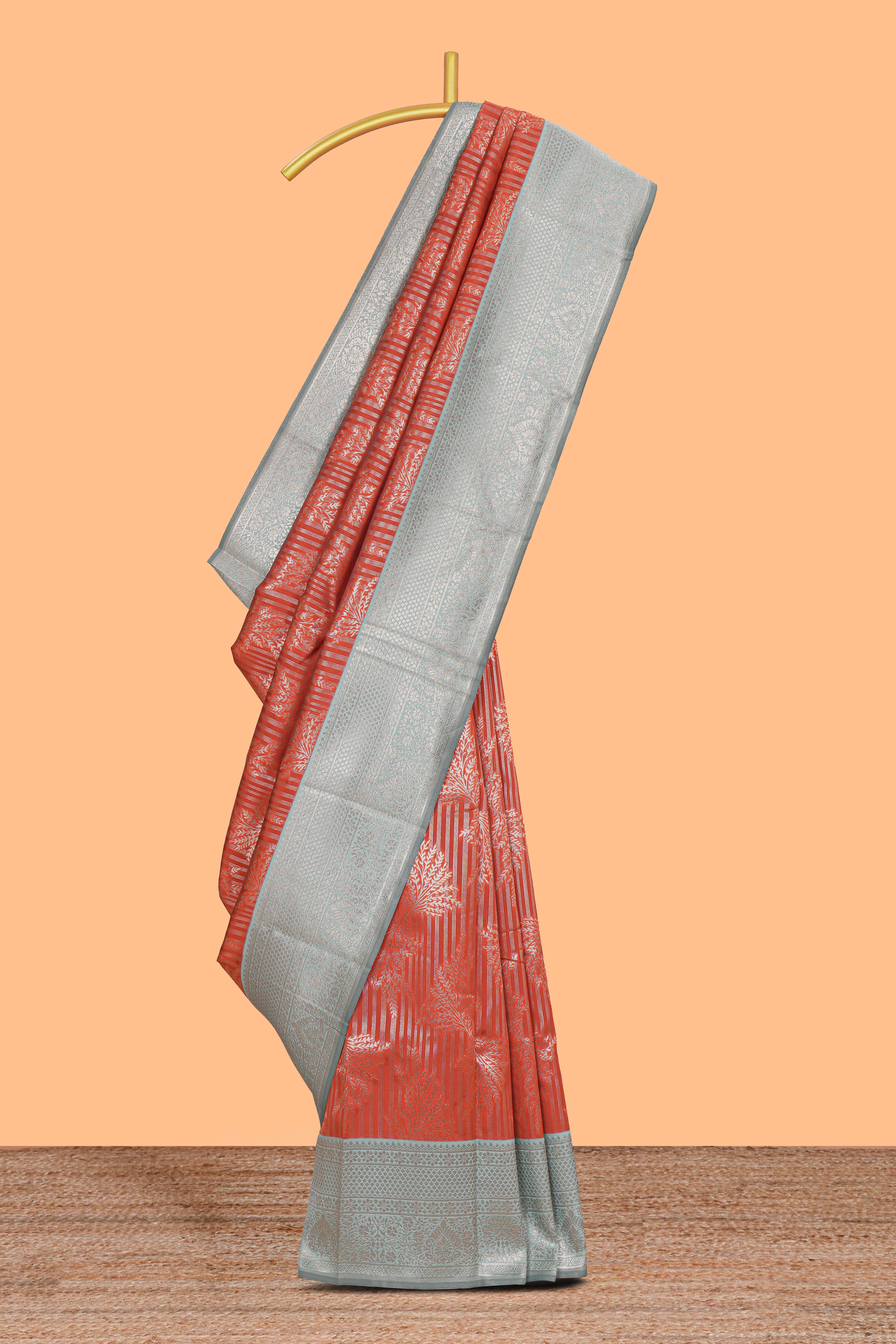 Orange striped floral design art silk saree with contrast zari border and zari motifs blouse
