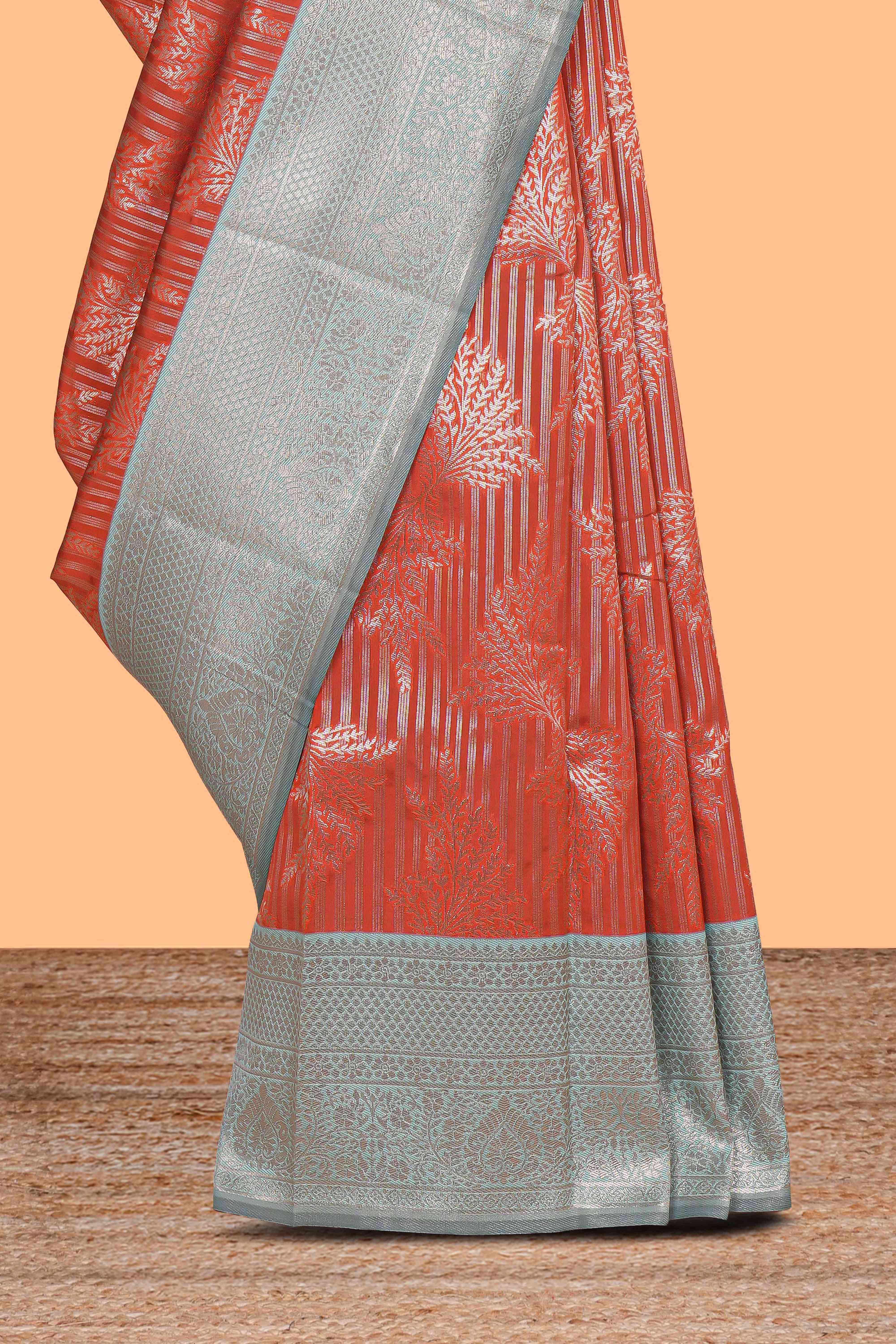 Orange striped floral design art silk saree with contrast zari border and zari motifs blouse