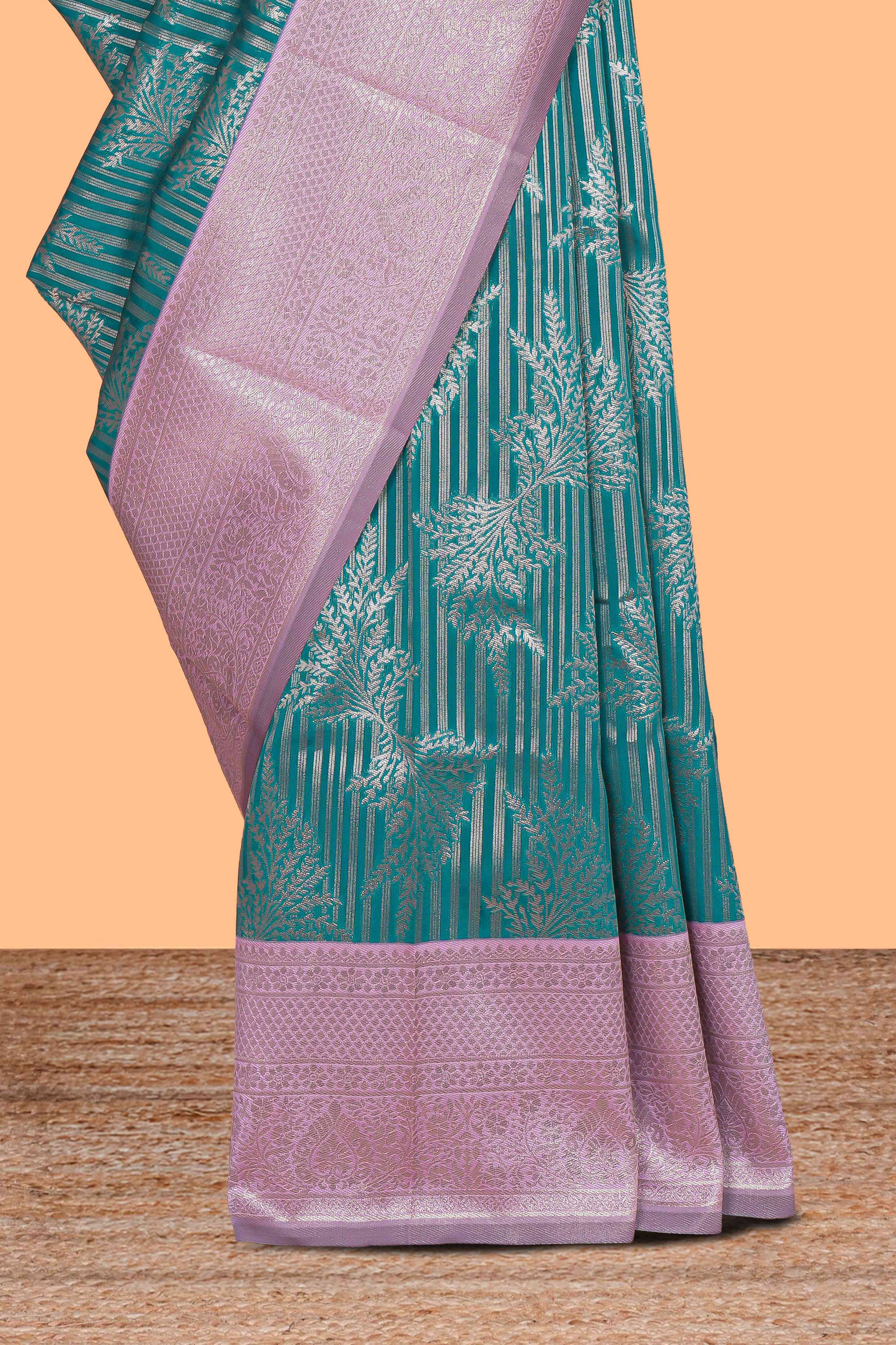 Teal green striped floral design art silk saree with contrast zari border and zari motifs blouse