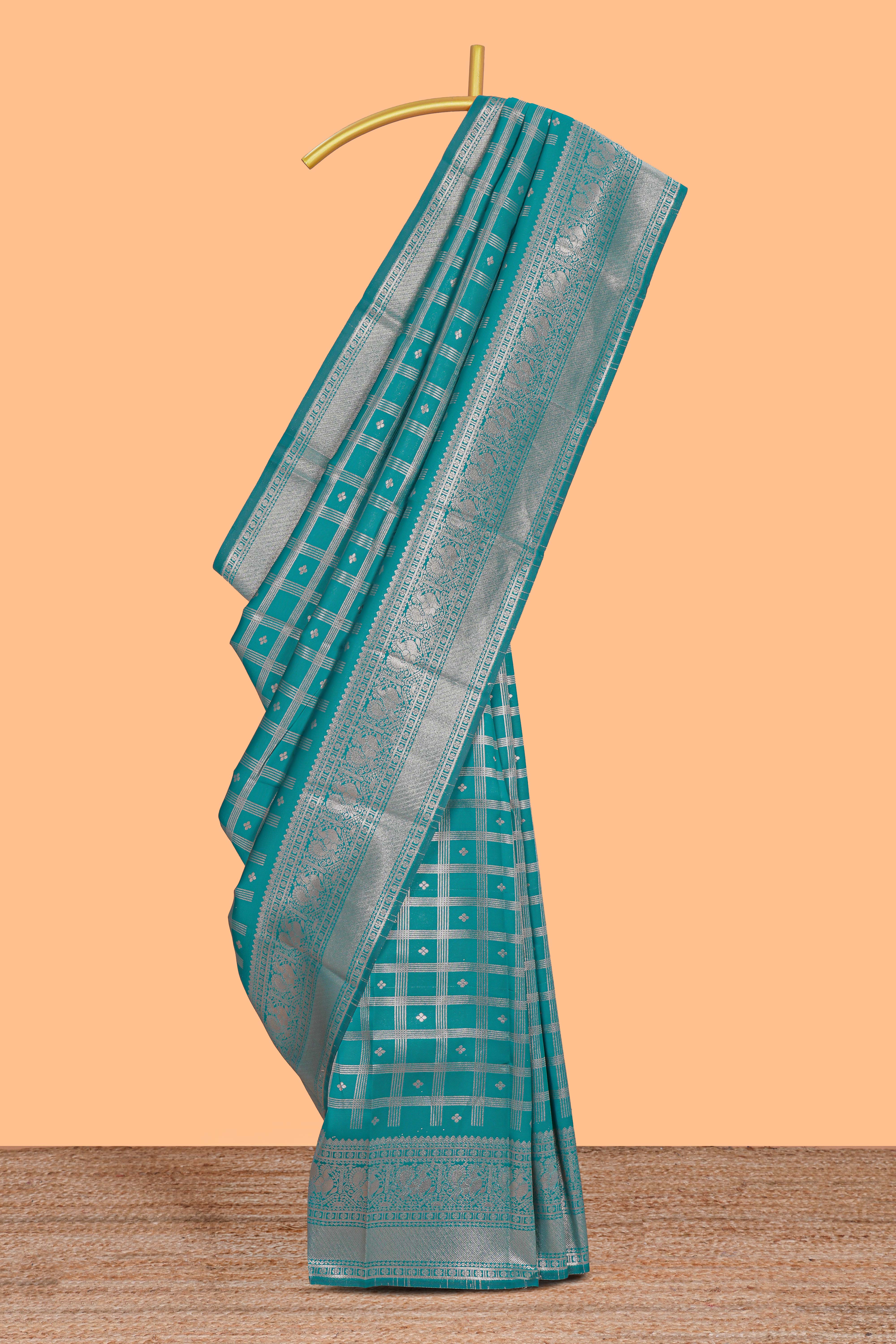 Teal green checked floral motifs design art silk saree with self zari border and matching motifs blouse