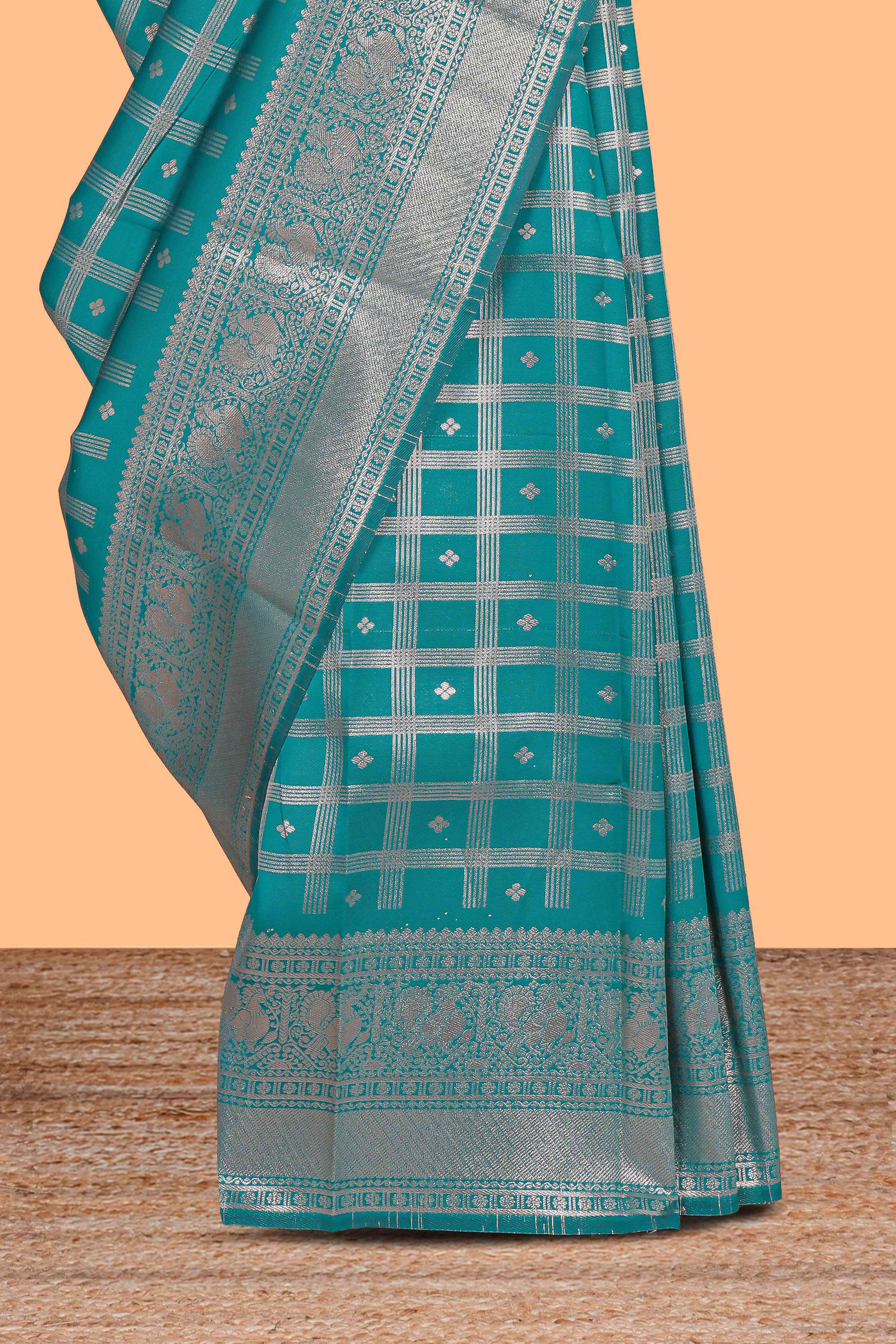 Teal green checked floral motifs design art silk saree with self zari border and matching motifs blouse