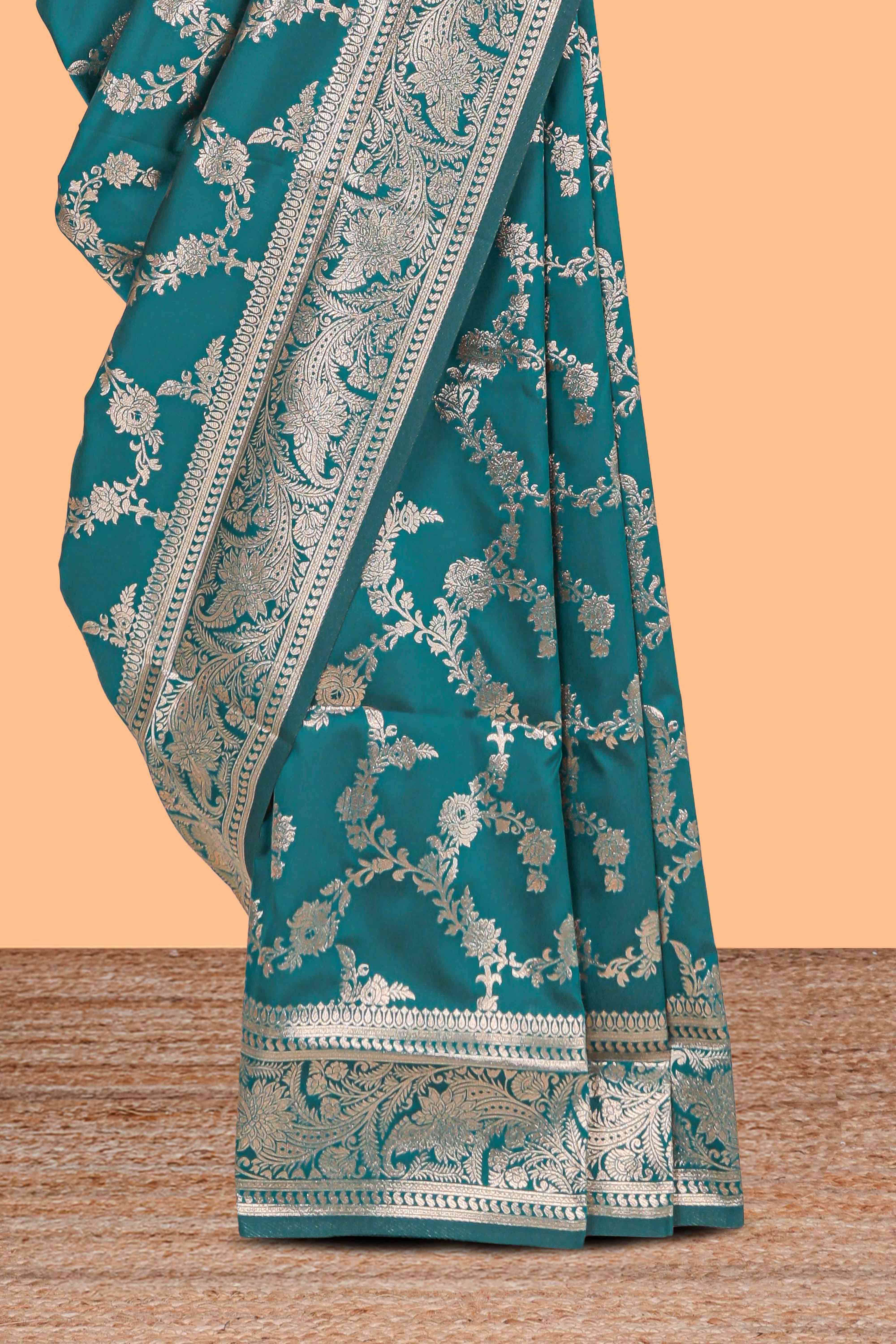 Green floral design art silk saree with self zari border and matching motifs blouse