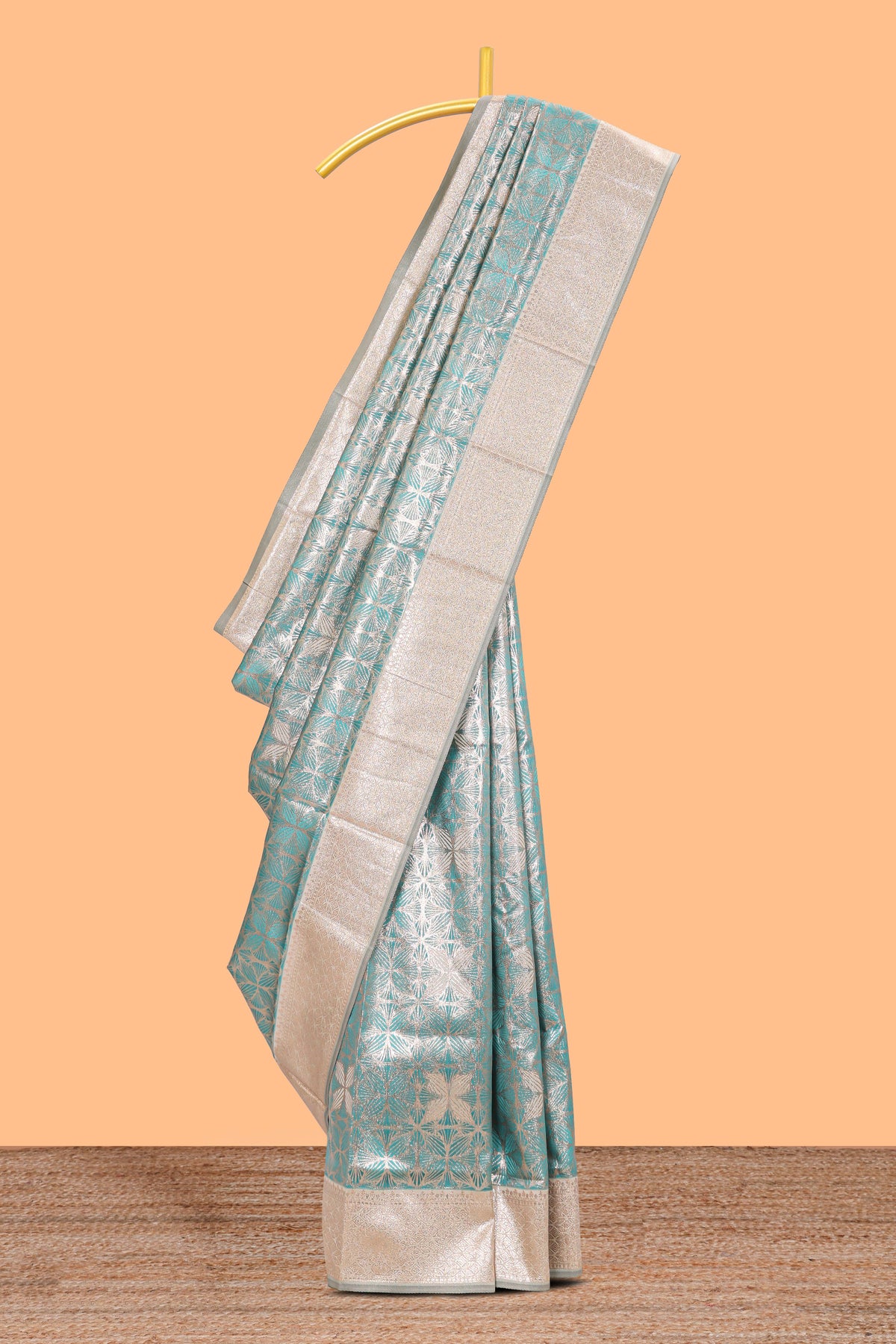Green geometric floral design art silk saree with contrast zari border and motifs blouse