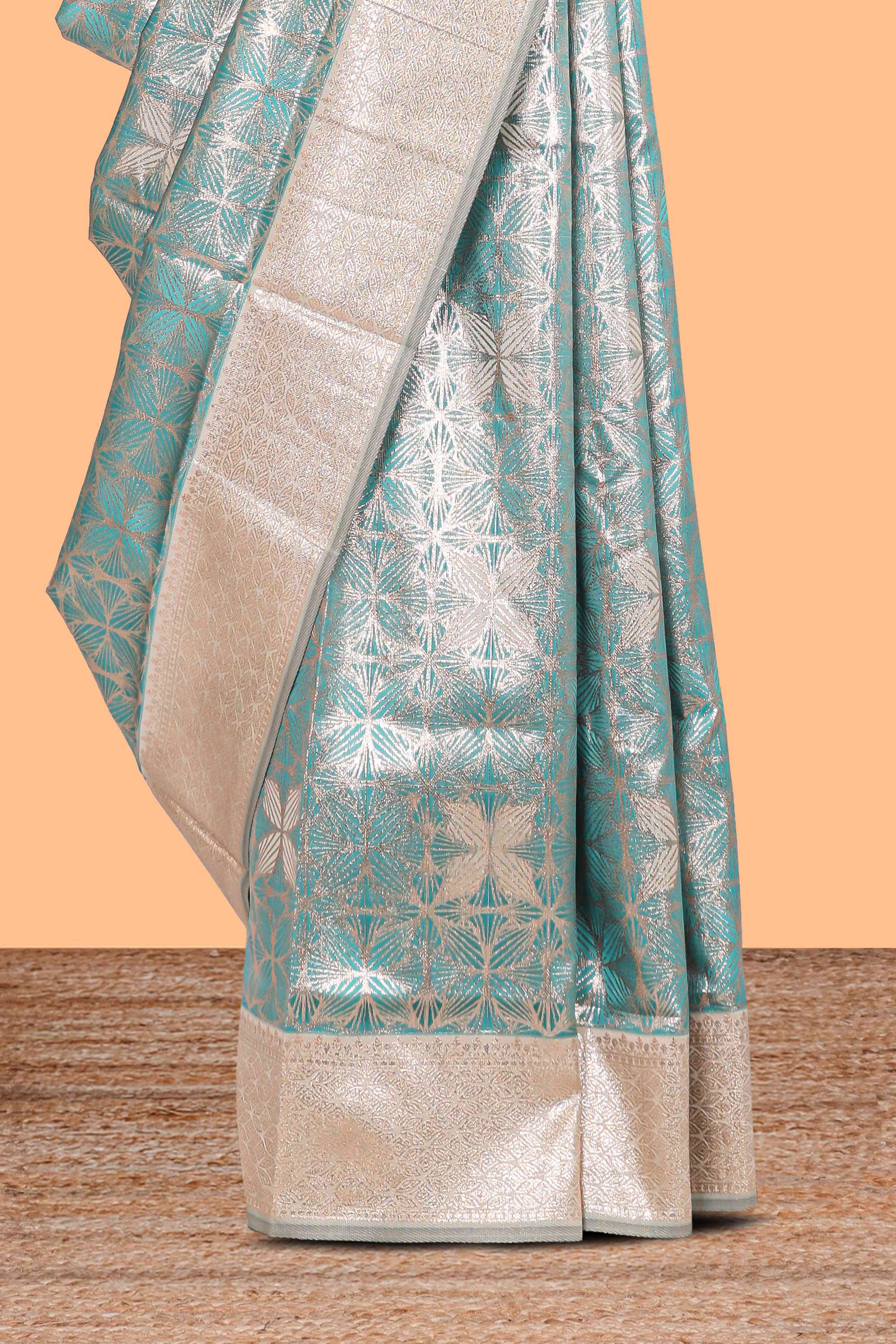 Green geometric floral design art silk saree with contrast zari border and motifs blouse