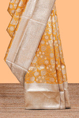 Golden yellow floral design art silk saree with contrast zari border and motifs blouse