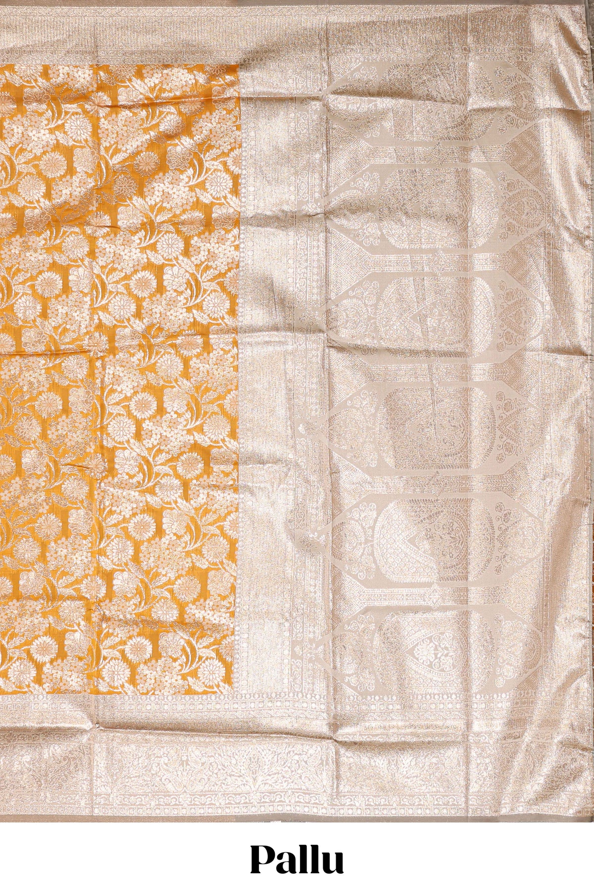Golden yellow floral design art silk saree with contrast zari border and motifs blouse