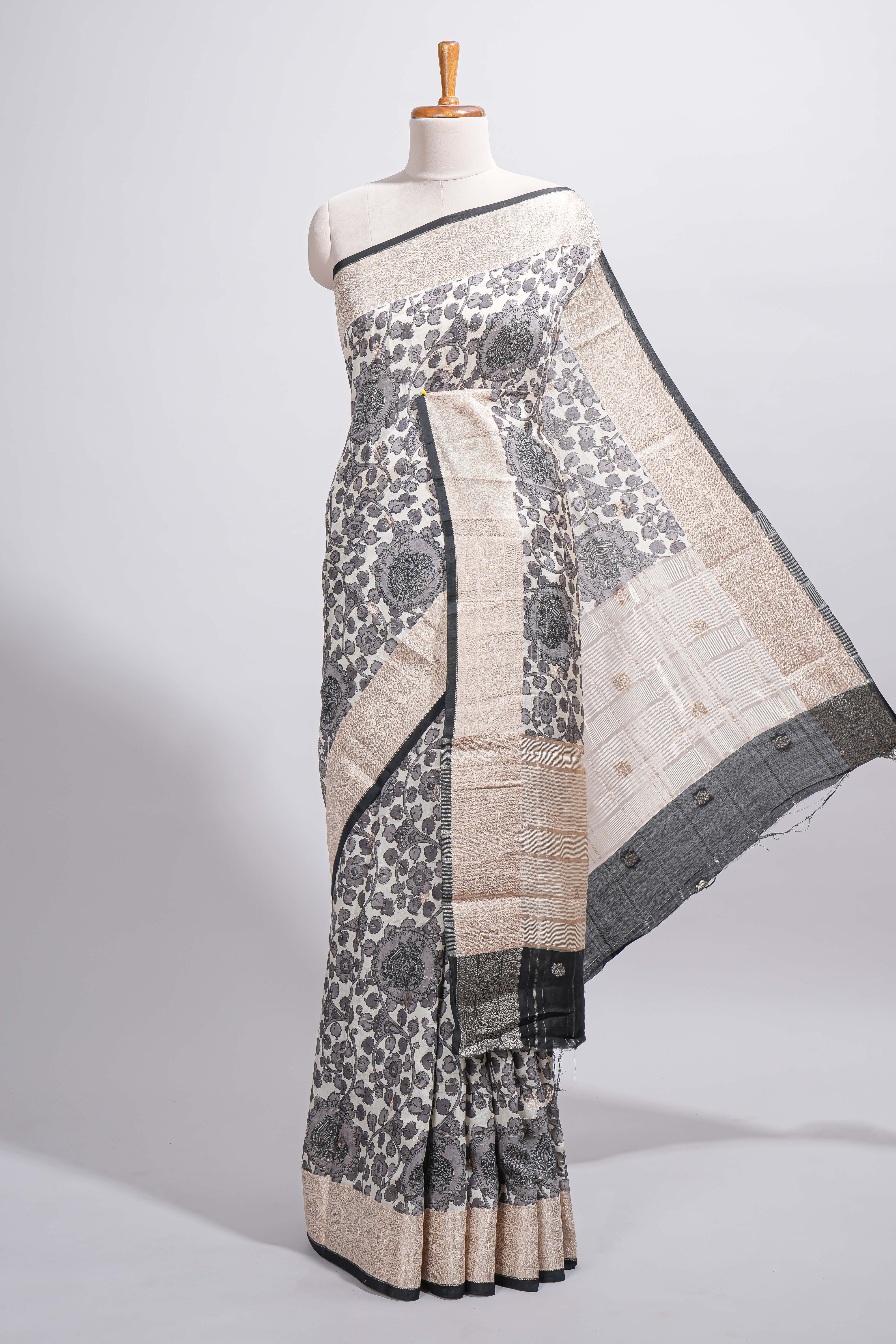 Elegant ivory Assam Silk saree with grey floral motifs detailed zari border and a contrast pallu along with contrast blouse