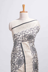 Elegant ivory Assam Silk saree with grey floral motifs detailed zari border and a contrast pallu along with contrast blouse