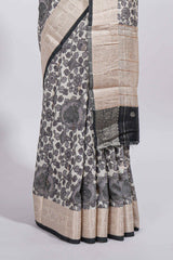 Elegant ivory Assam Silk saree with grey floral motifs detailed zari border and a contrast pallu along with contrast blouse