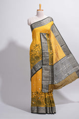 Mustard yellow Assam Silk saree floral and paisley motifs with a rich grey zari border and contrast pallu along with matching blouse