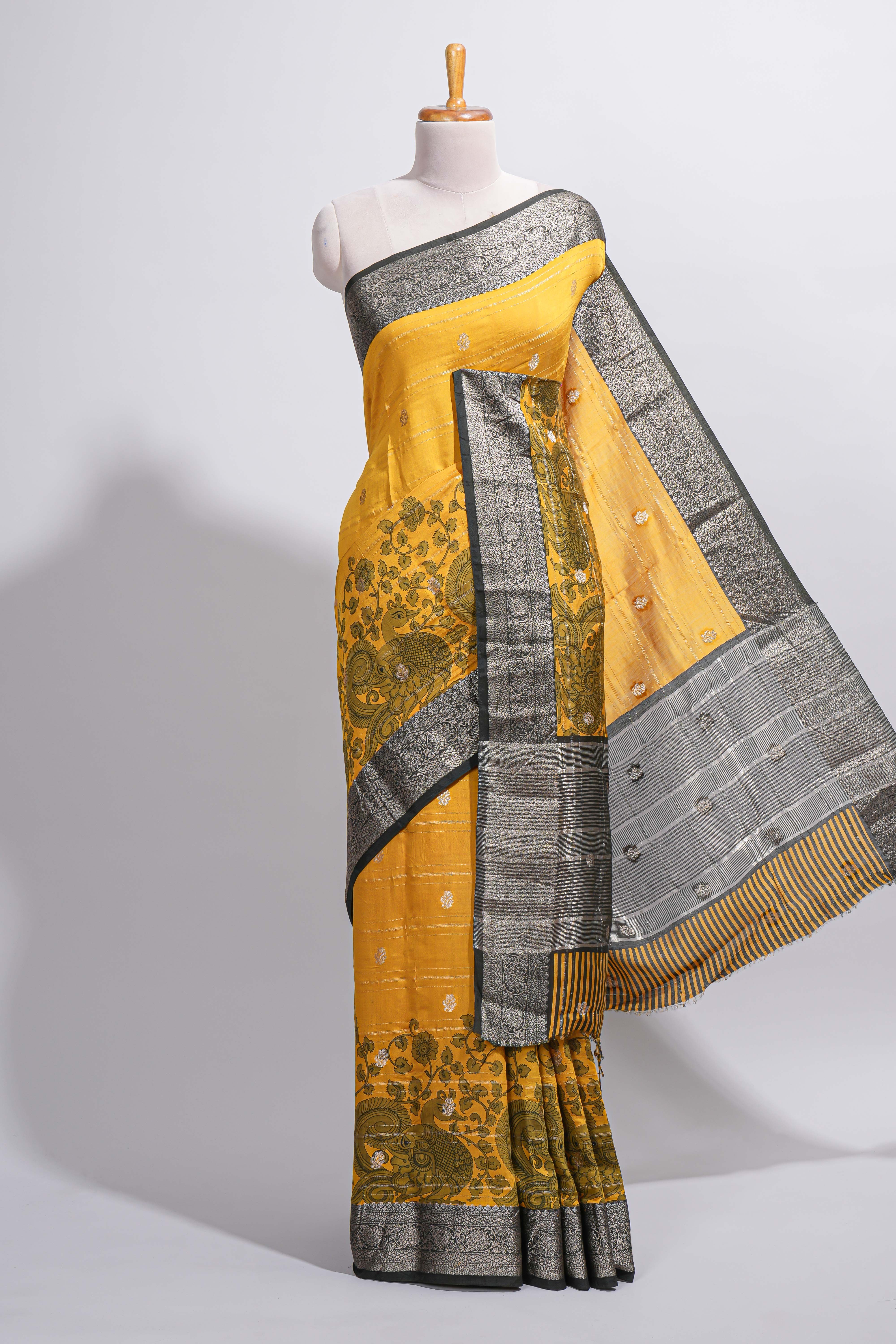 Mustard yellow Assam Silk saree floral and paisley motifs with a rich grey zari border and contrast pallu along with matching blouse