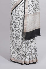 Elegant white Assam Silk saree traditional folk motif print floral patterns and a contrast black woven border The detailed pallu along with contrast blouse