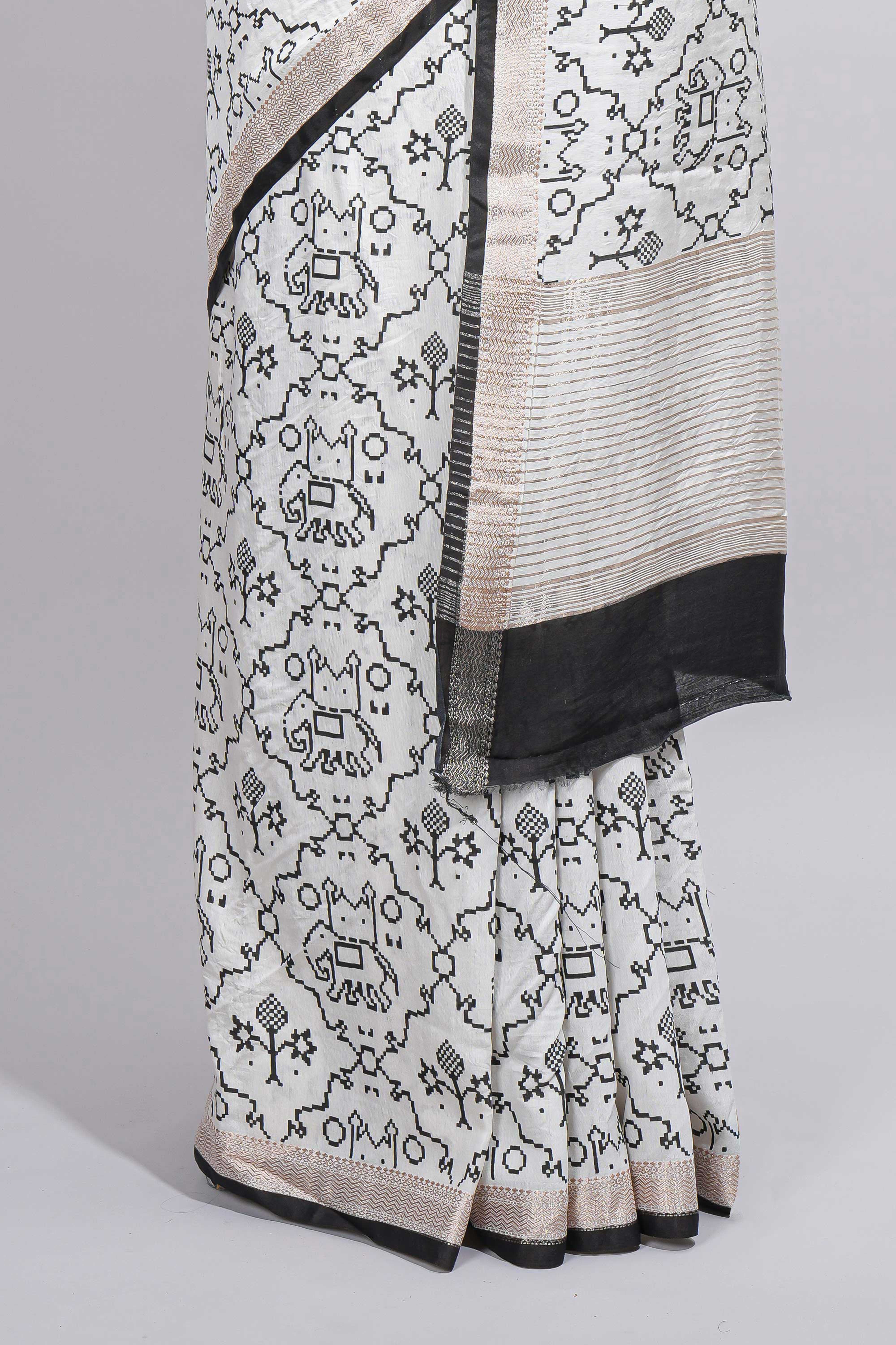 Elegant white Assam Silk saree traditional folk motif print floral patterns and a contrast black woven border The detailed pallu along with contrast blouse