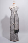 Grey colour Assam Silk saree traditional folk motif print floral patterns and a contrast woven border The detailed pallu along with contrast blouse