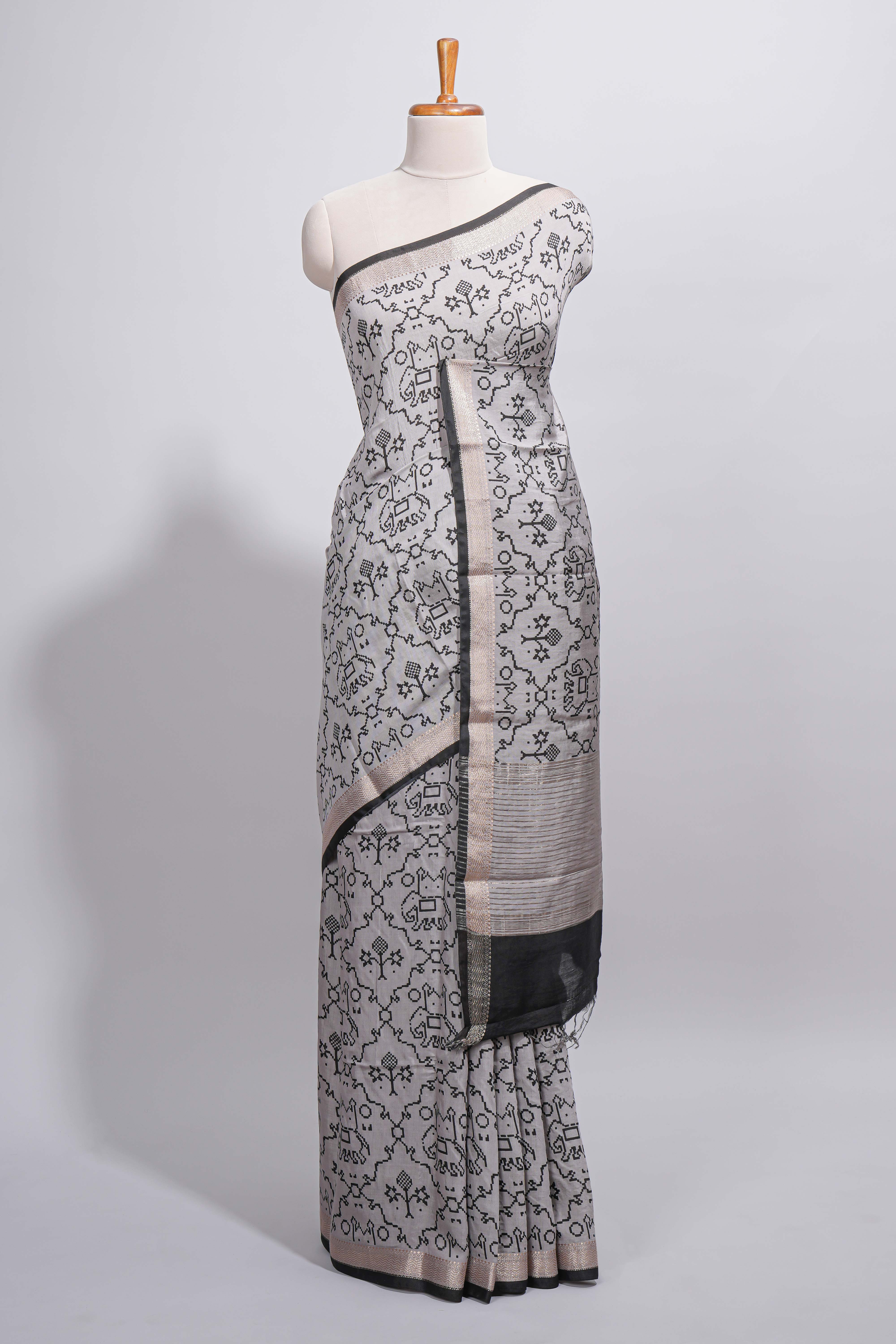 Grey colour Assam Silk saree traditional folk motif print floral patterns and a contrast woven border The detailed pallu along with contrast blouse