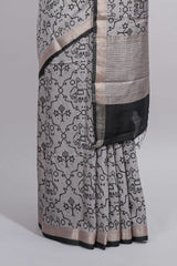 Grey colour Assam Silk saree traditional folk motif print floral patterns and a contrast woven border The detailed pallu along with contrast blouse