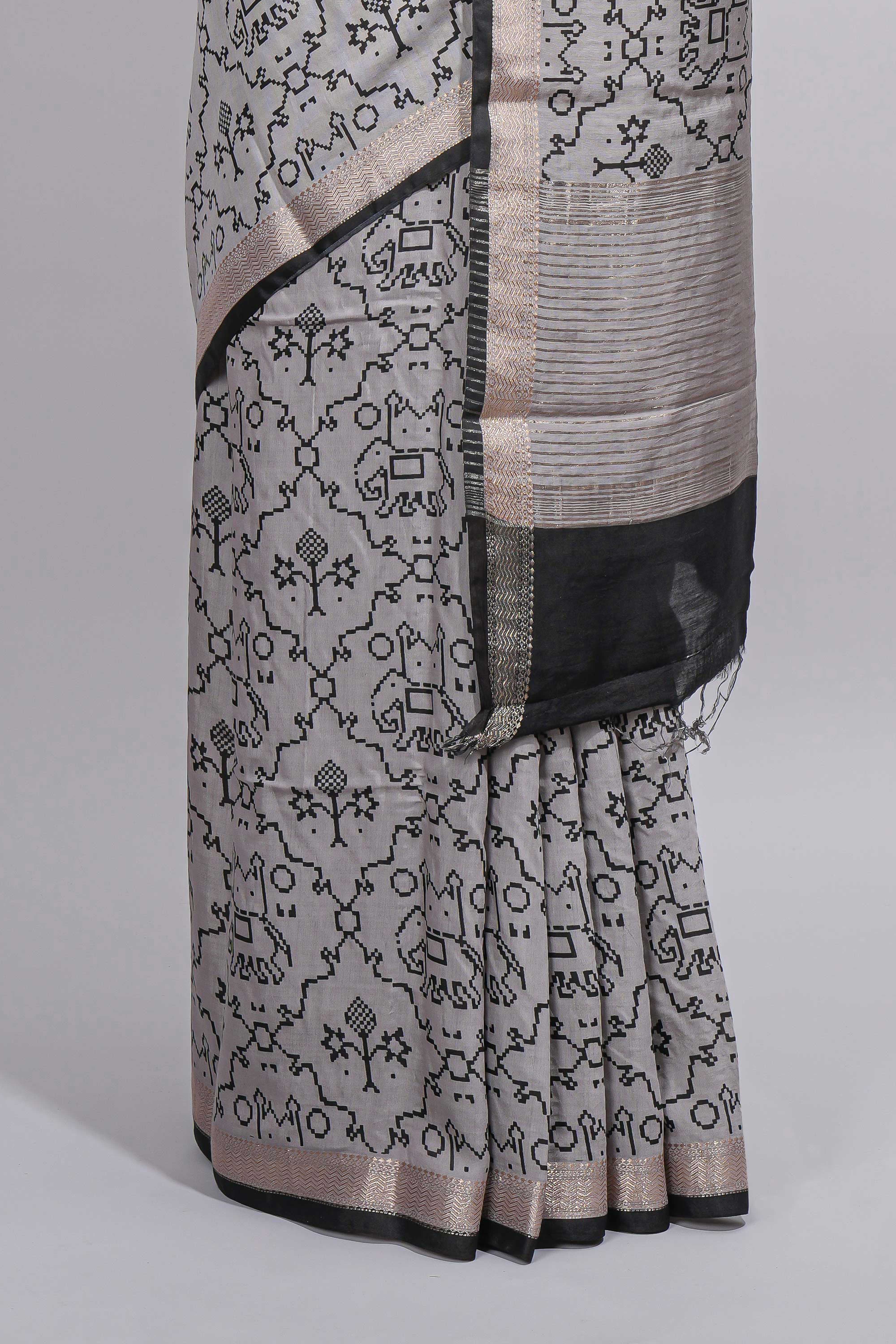 Grey colour Assam Silk saree traditional folk motif print floral patterns and a contrast woven border The detailed pallu along with contrast blouse