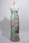 Pastel green Assam Silk saree withfloral woven motifs rich zari border and contrastpallu with fine stripes and tassel detailing along with blouse piece