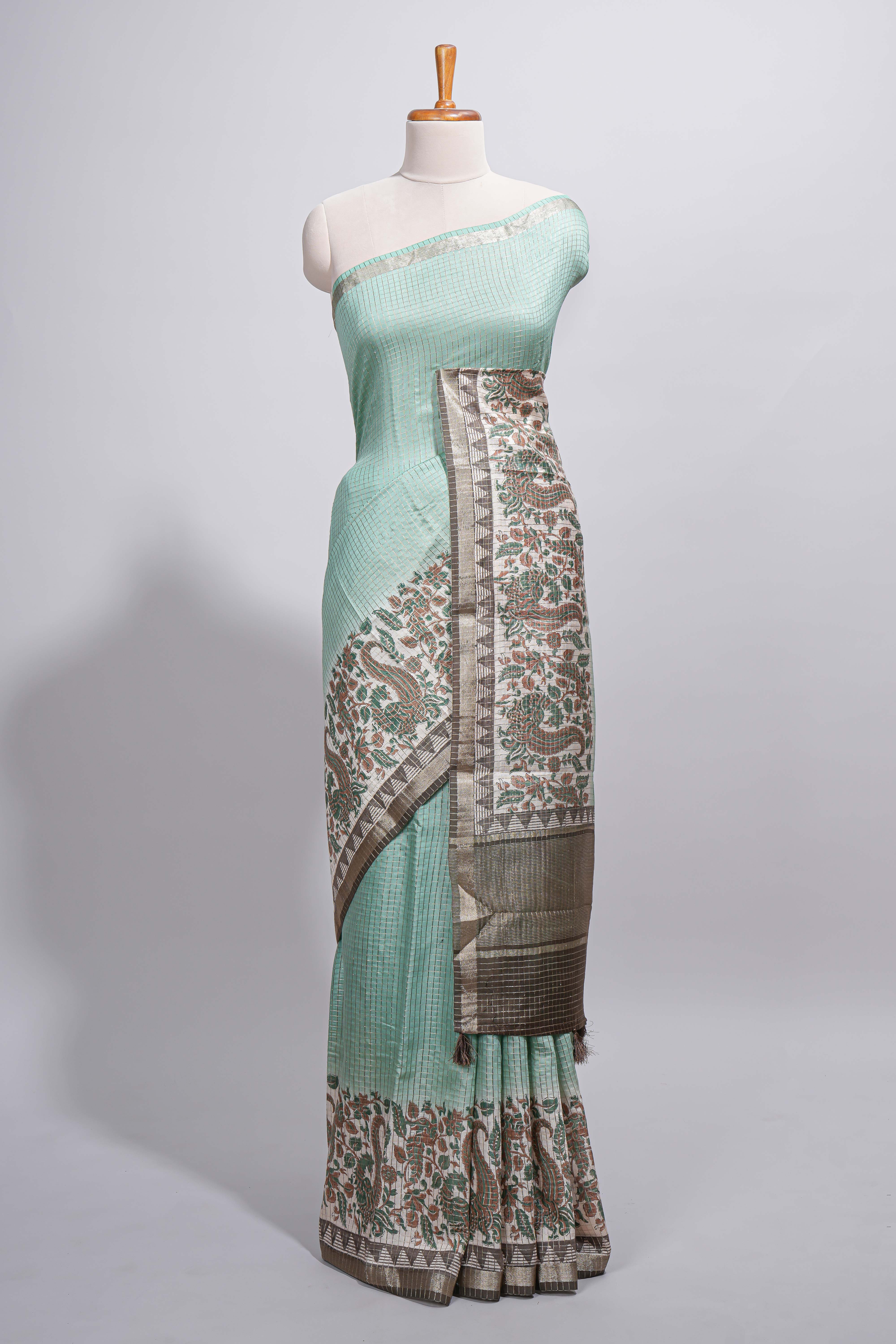 Pastel green Assam Silk saree withfloral woven motifs rich zari border and contrastpallu with fine stripes and tassel detailing along with blouse piece