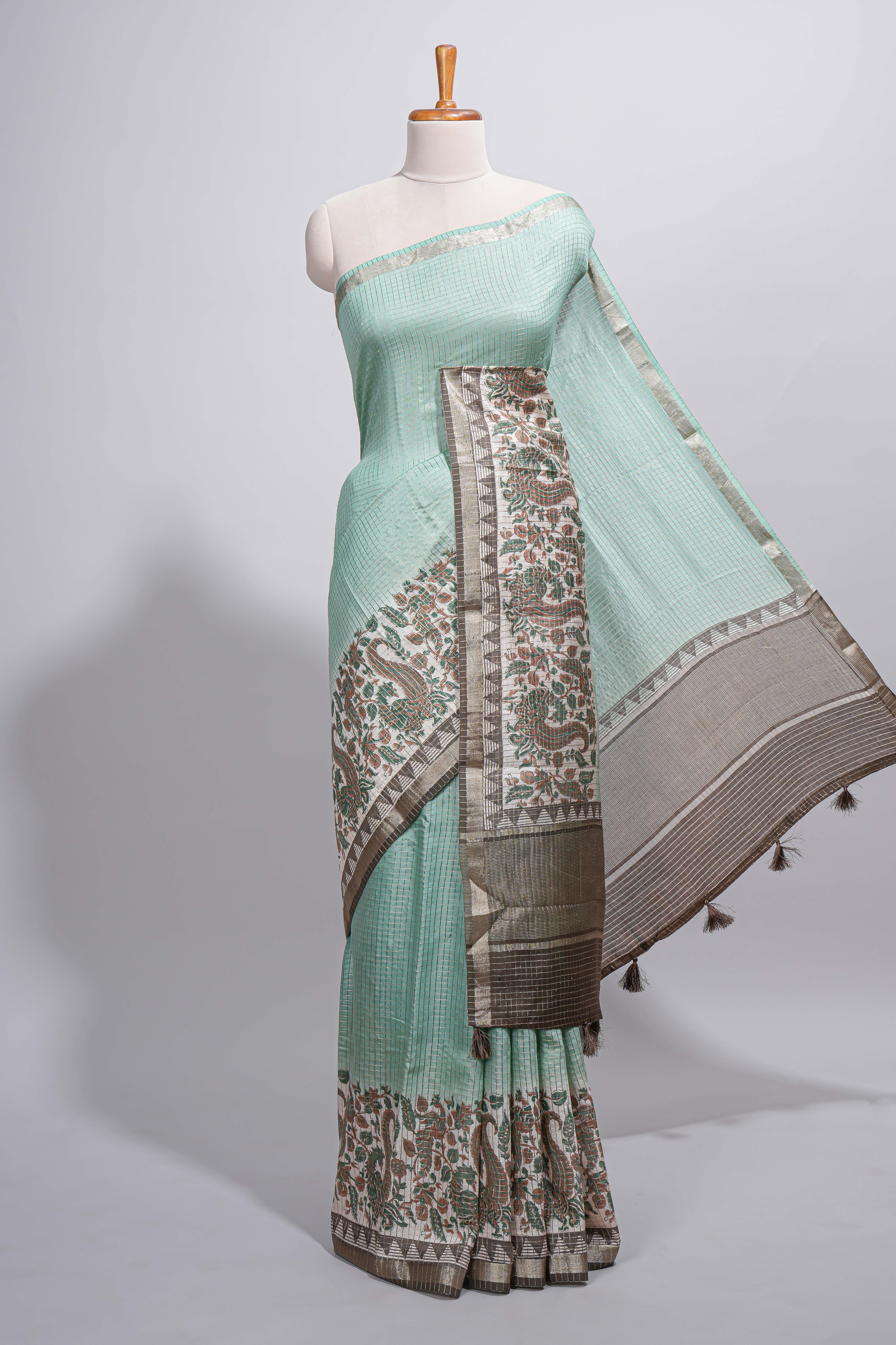 Pastel green Assam Silk saree withfloral woven motifs rich zari border and contrastpallu with fine stripes and tassel detailing along with blouse piece