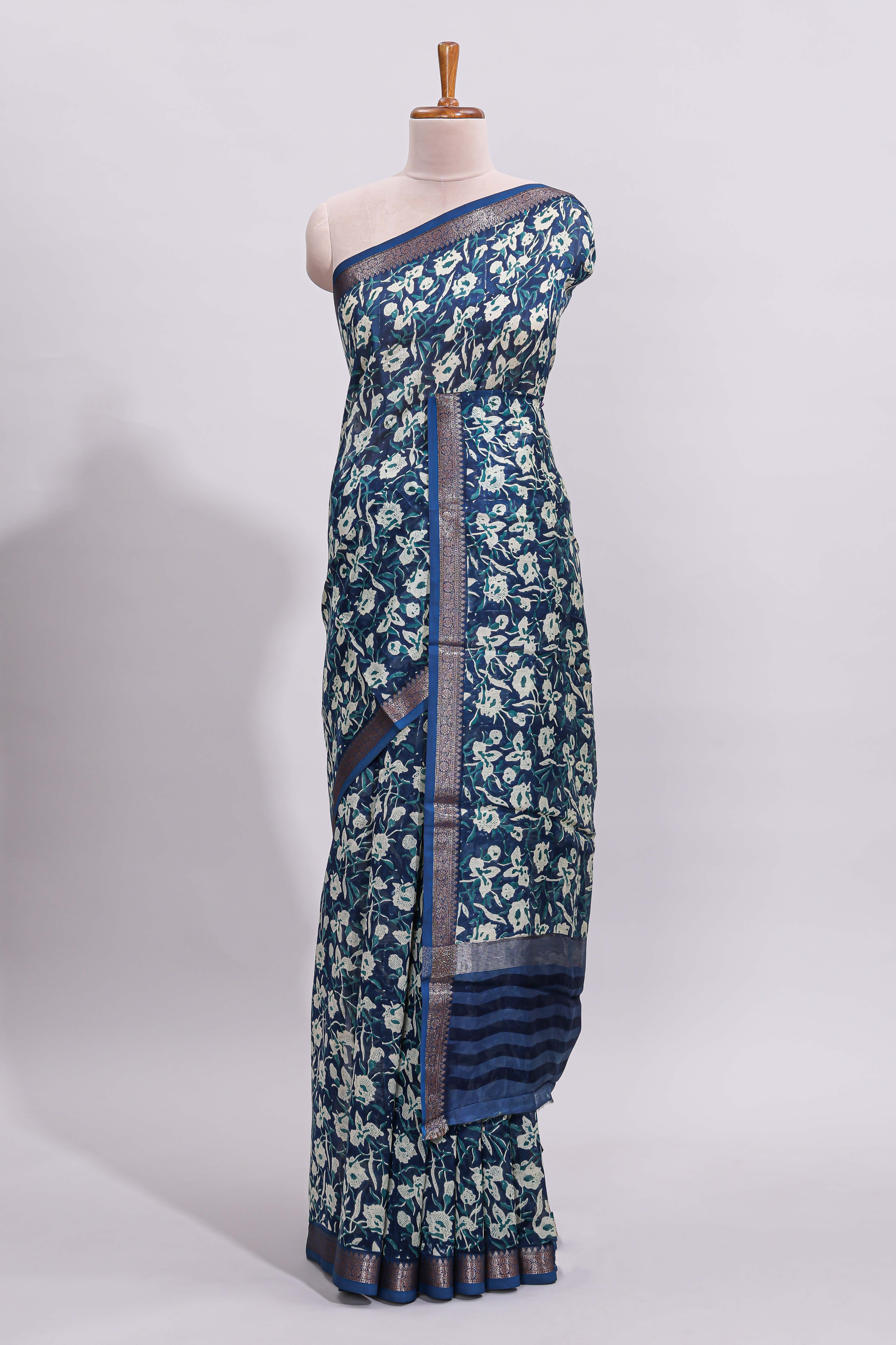 Blue floral design assam silk saree with self zari border and striped blouse