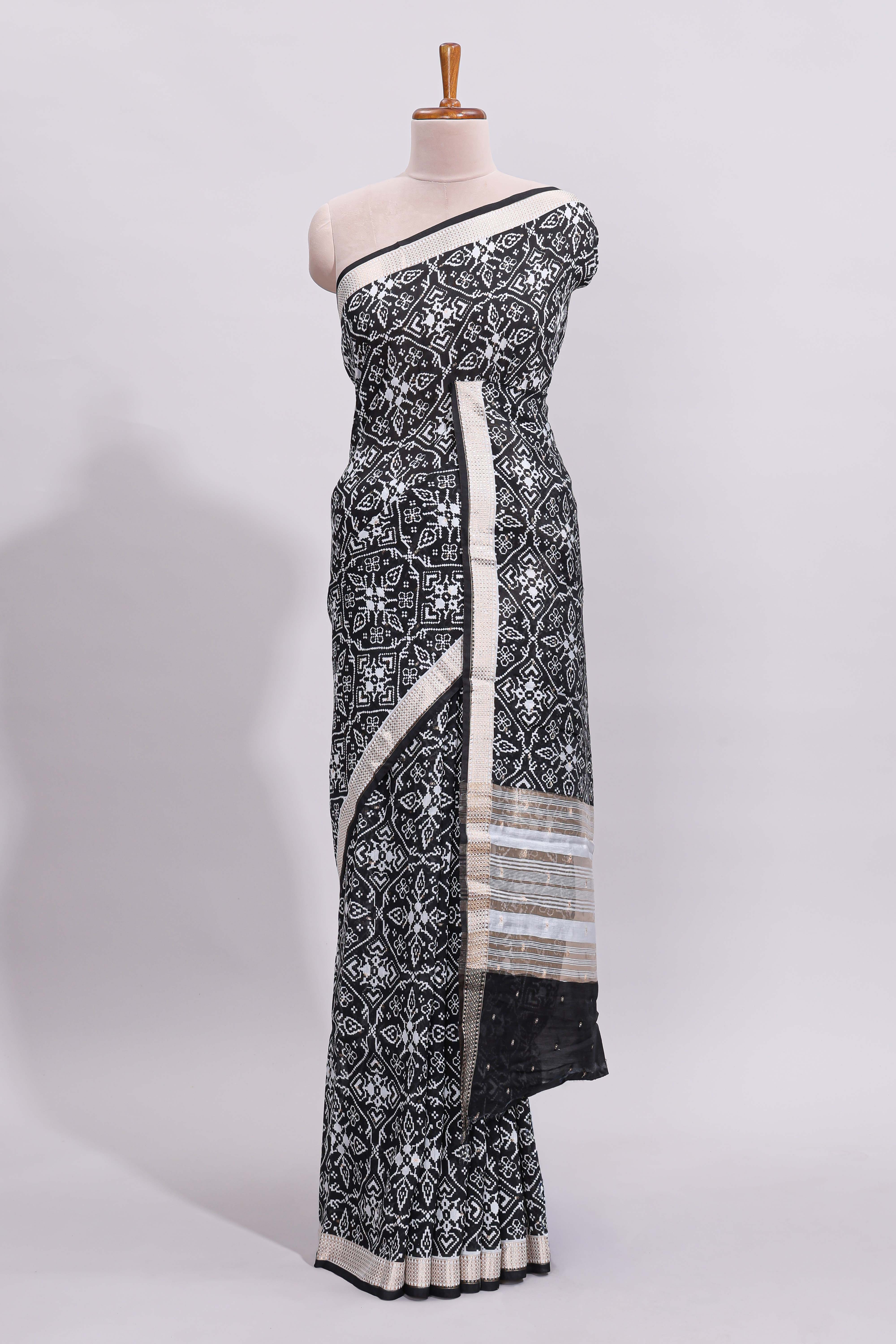 Black ikkat style floral design assam silk saree with self zari border and matching motifs blouse