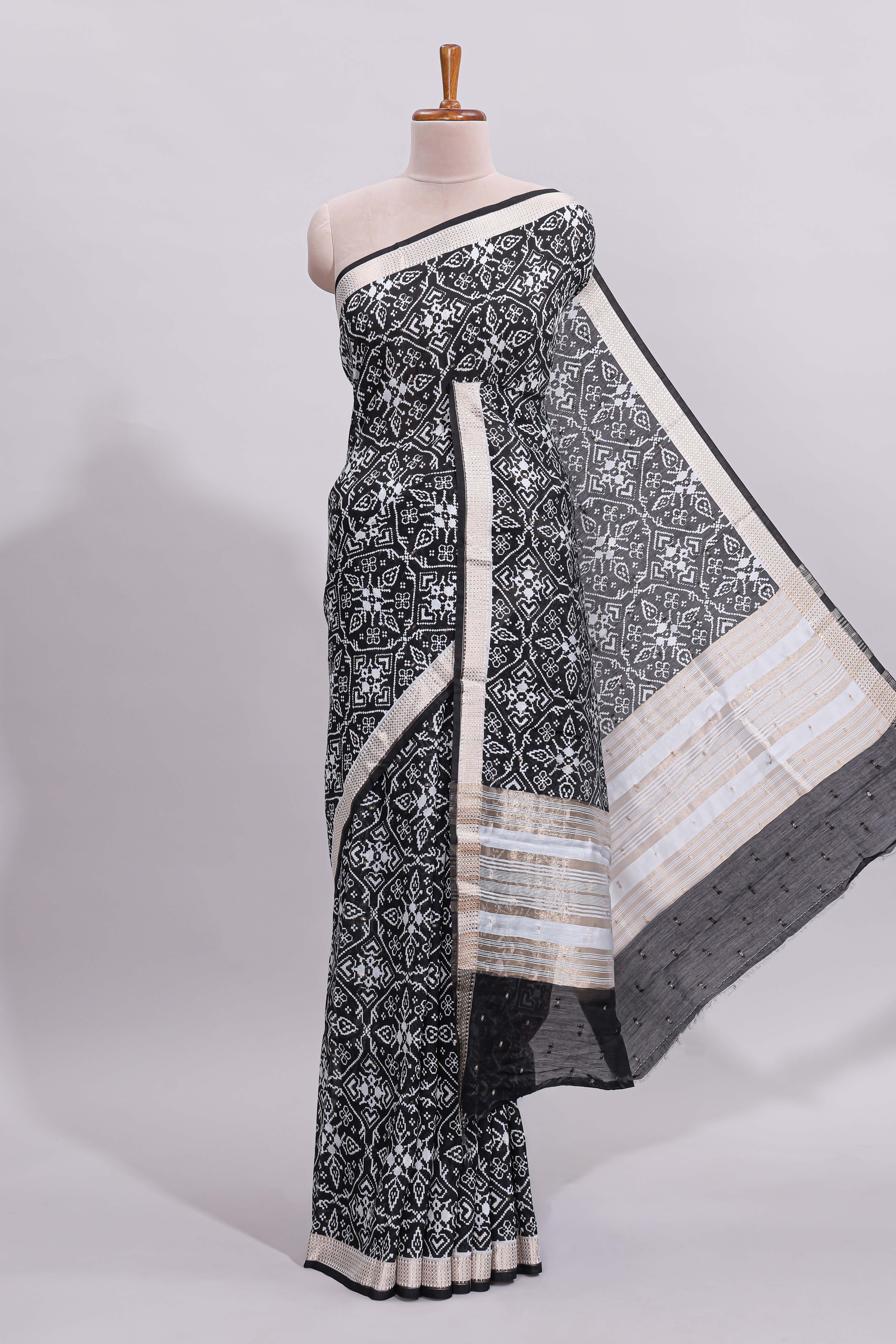 Black ikkat style floral design assam silk saree with self zari border and matching motifs blouse