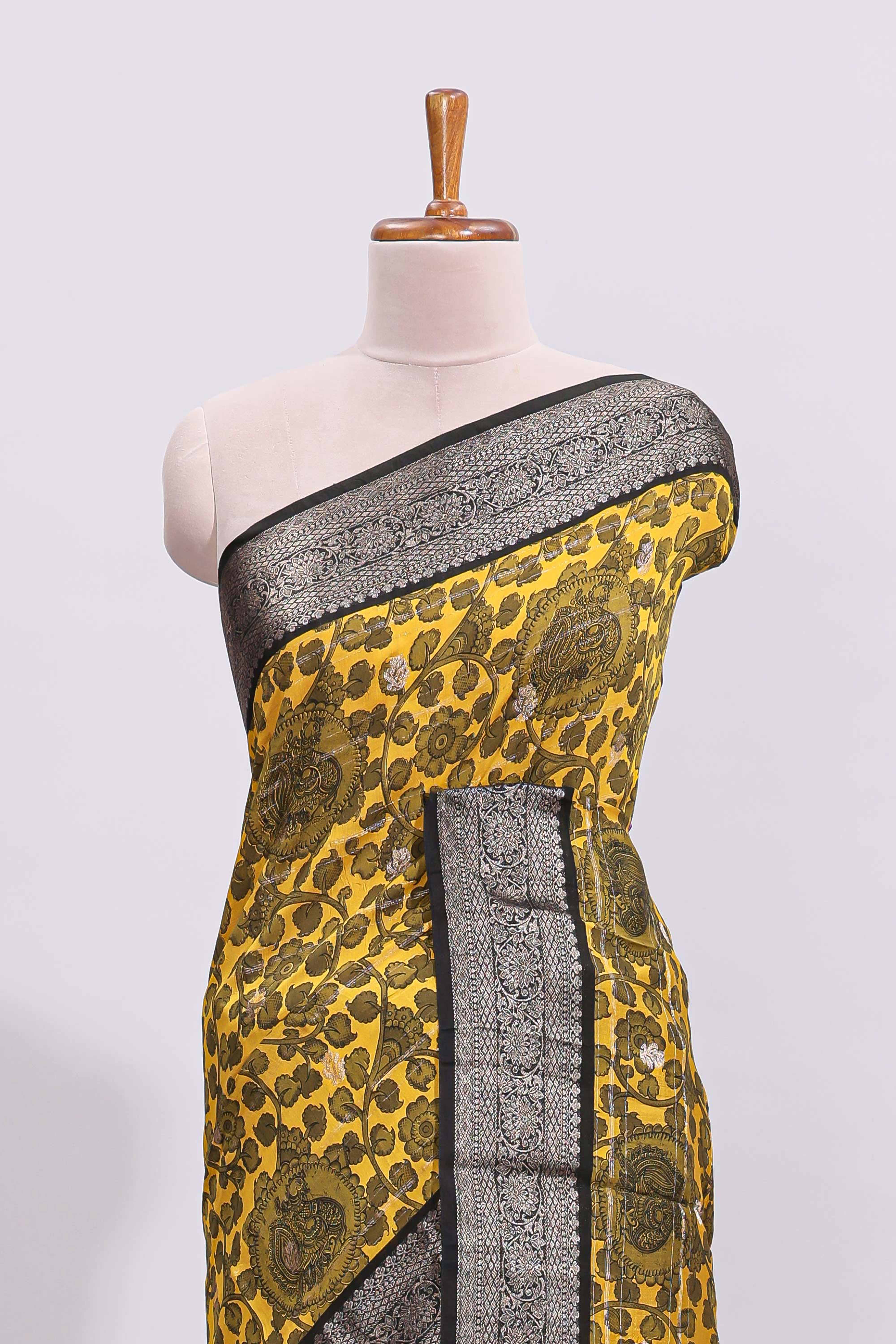 Yellow floral design assam silk saree with contrast zari border and matching motifs blouse