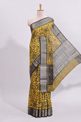 Yellow floral design assam silk saree with contrast zari border and matching motifs blouse