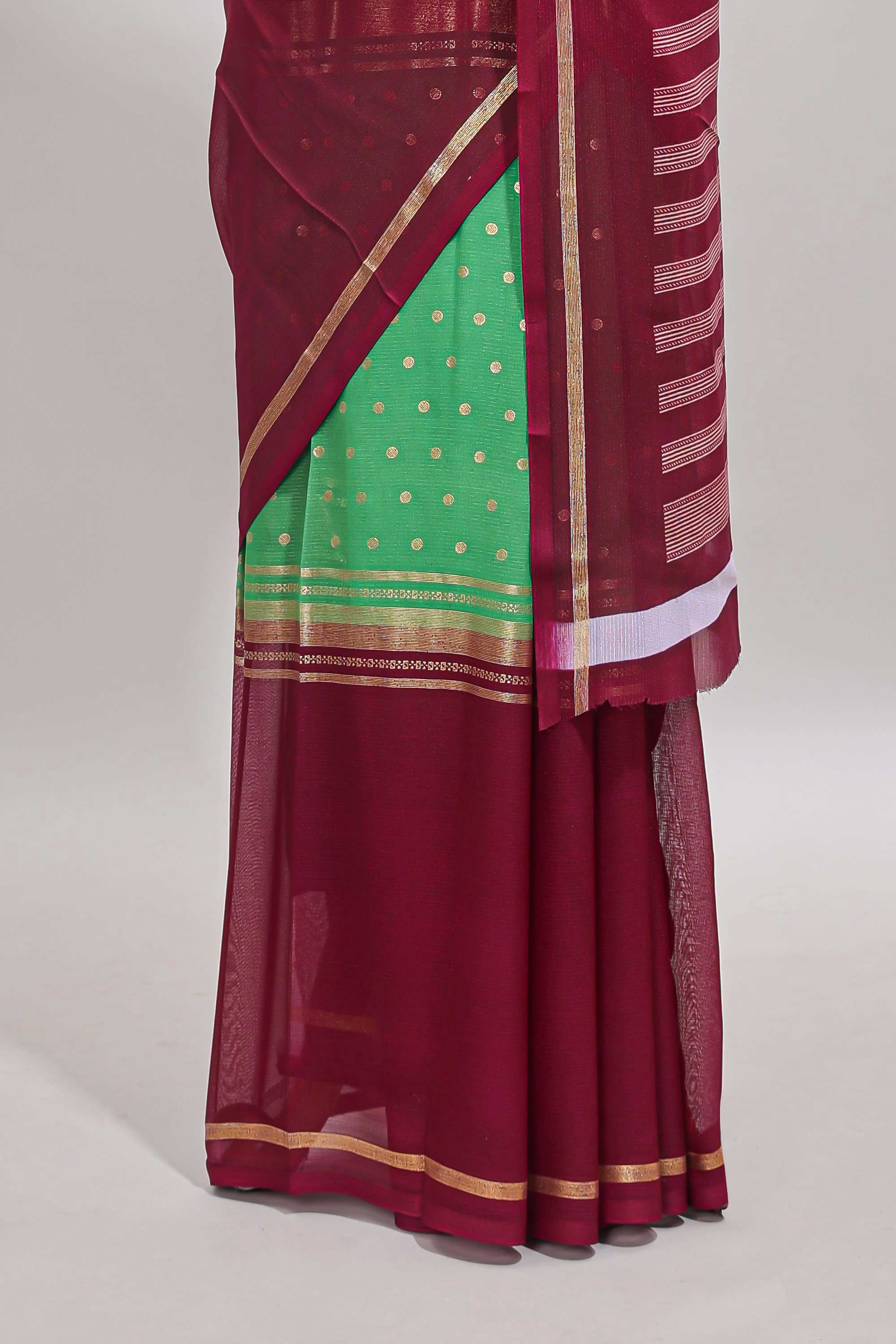 Green zari motifs semi soft silk saree with contrast border and striped pallu