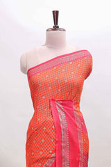 Orange checked semi soft silk saree with contrast border and striped pallu