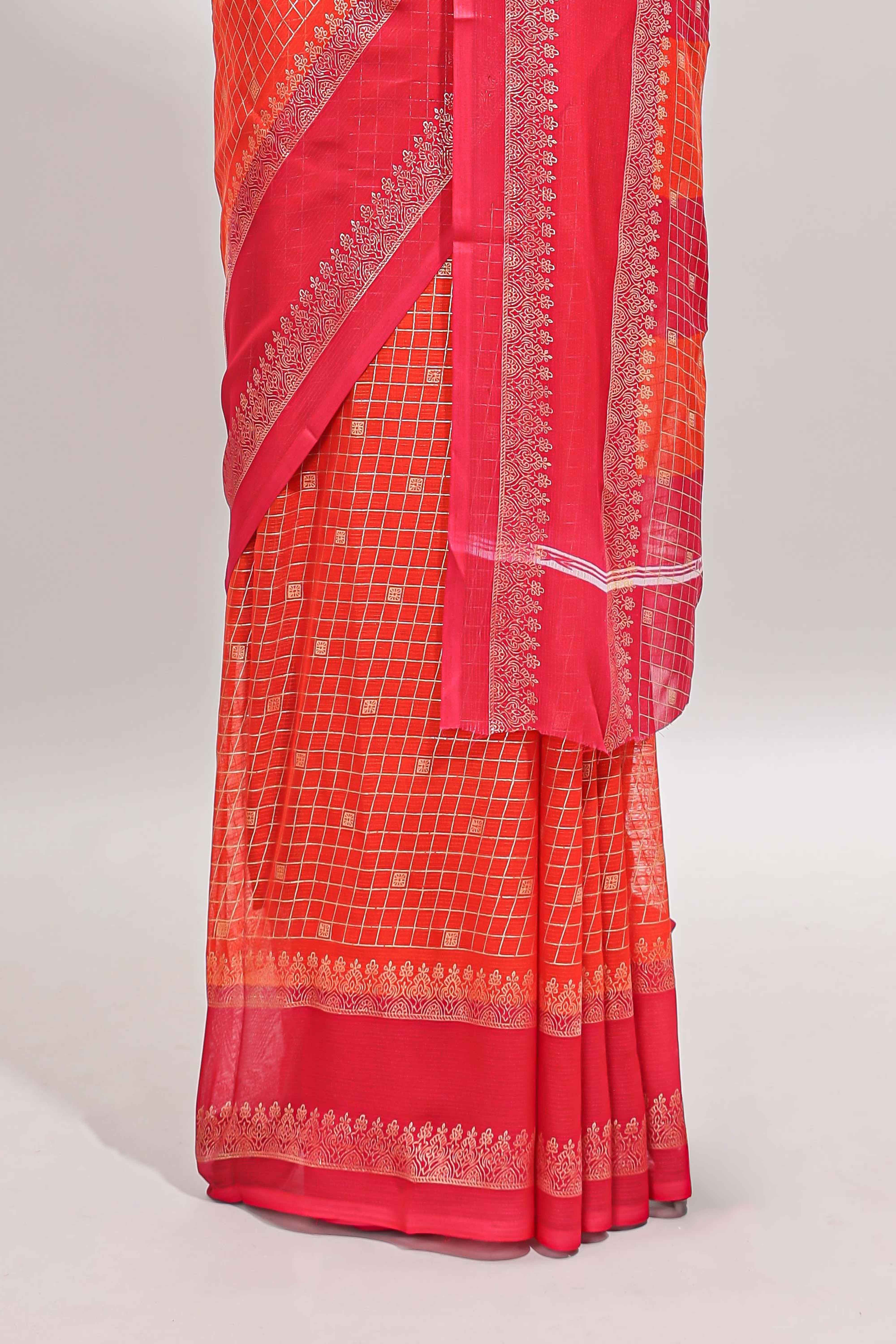 Orange checked semi soft silk saree with contrast border and striped pallu