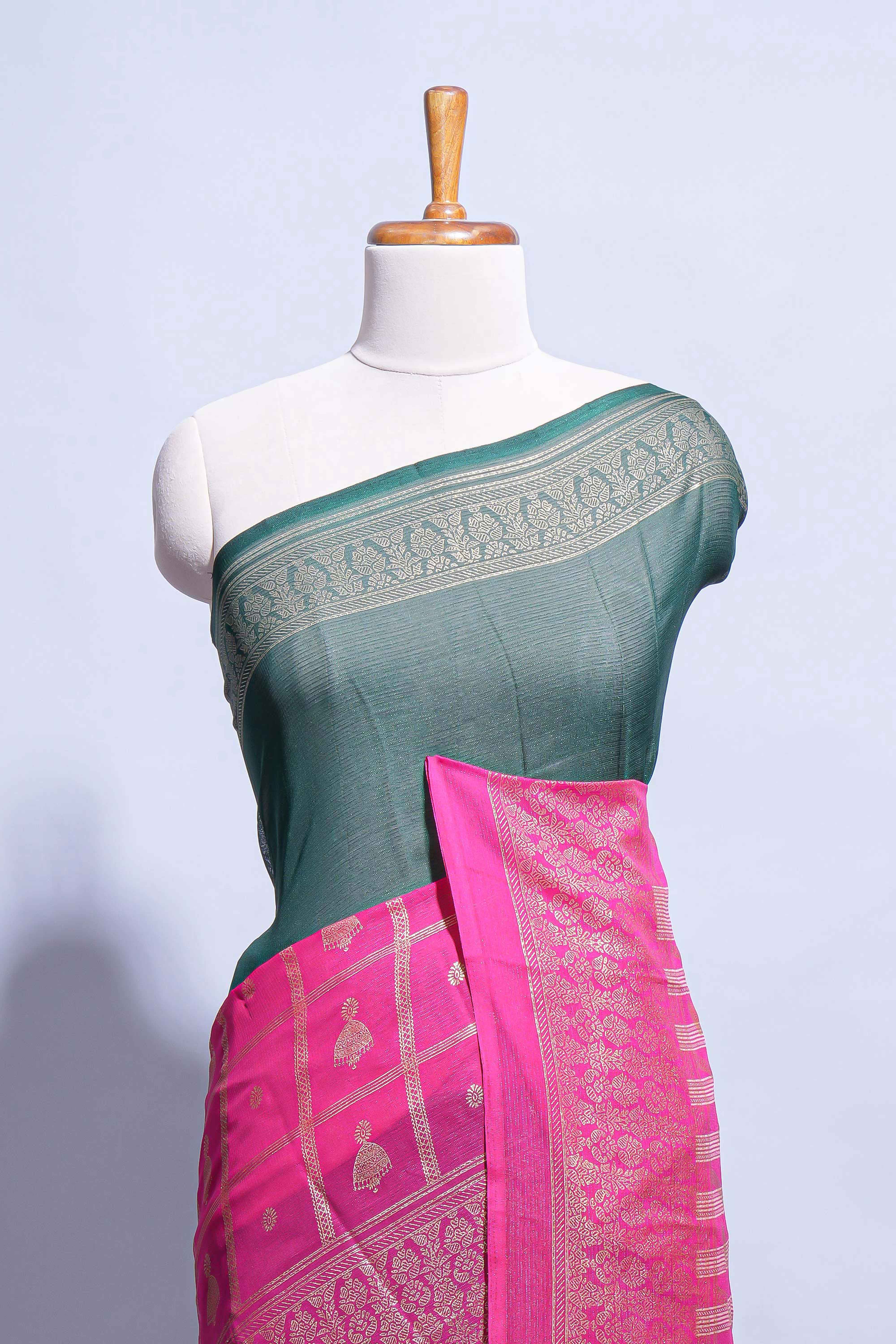 Dark green color budget silk saree with contrast foil print border and contrast pallu along with contrast blouse piece