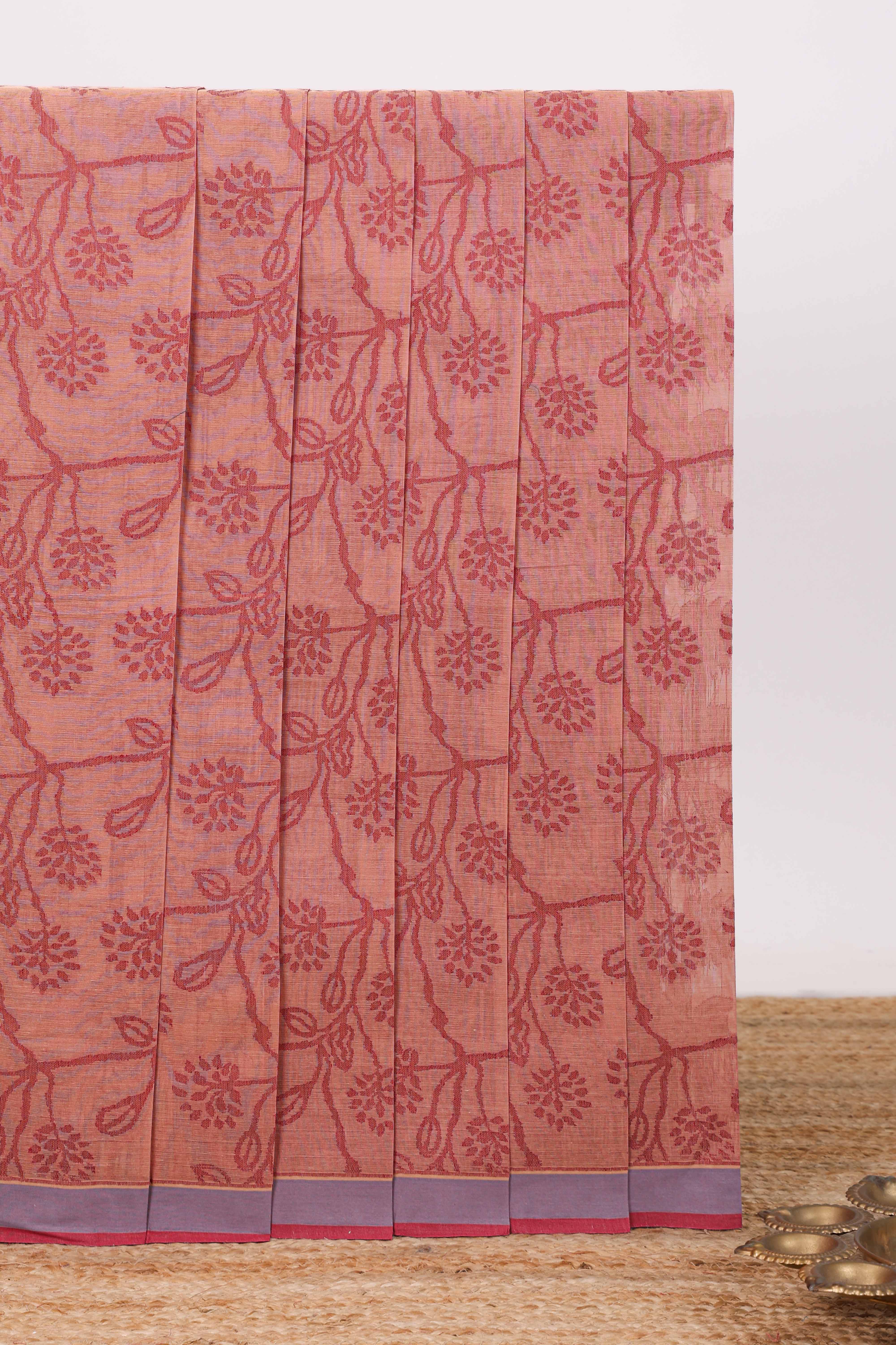 Peach floral designed chirala cotton saree with contrast border and self floral motif pallu