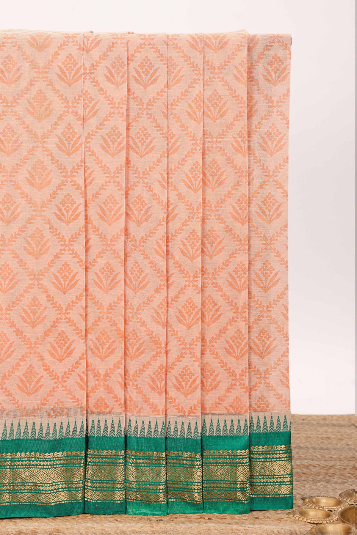 Peach geometric floral design chirala cotton saree with contrast border and zari design pallu