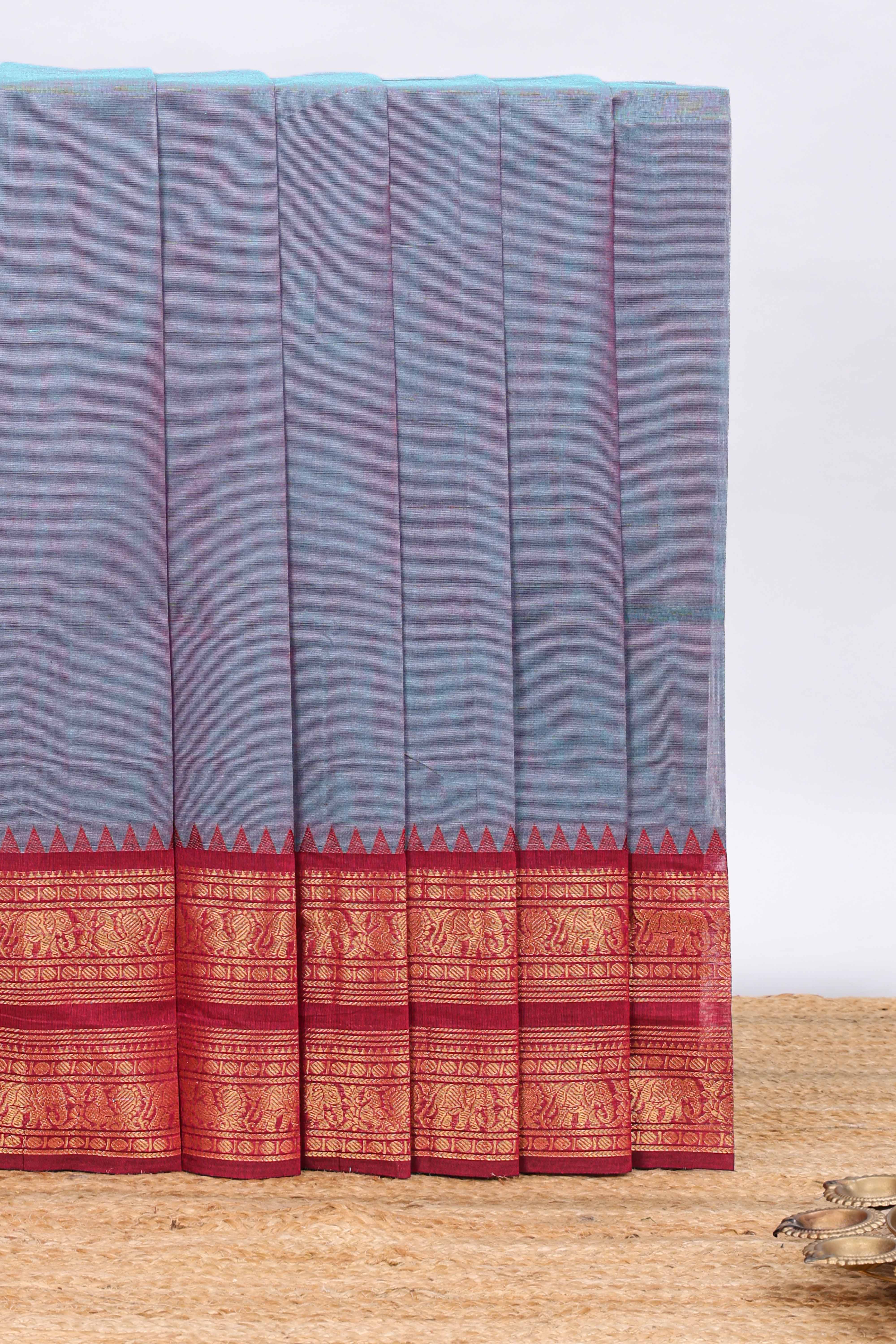 Powder blue plain chettinad cotton saree with contrast checked border and matching blouse