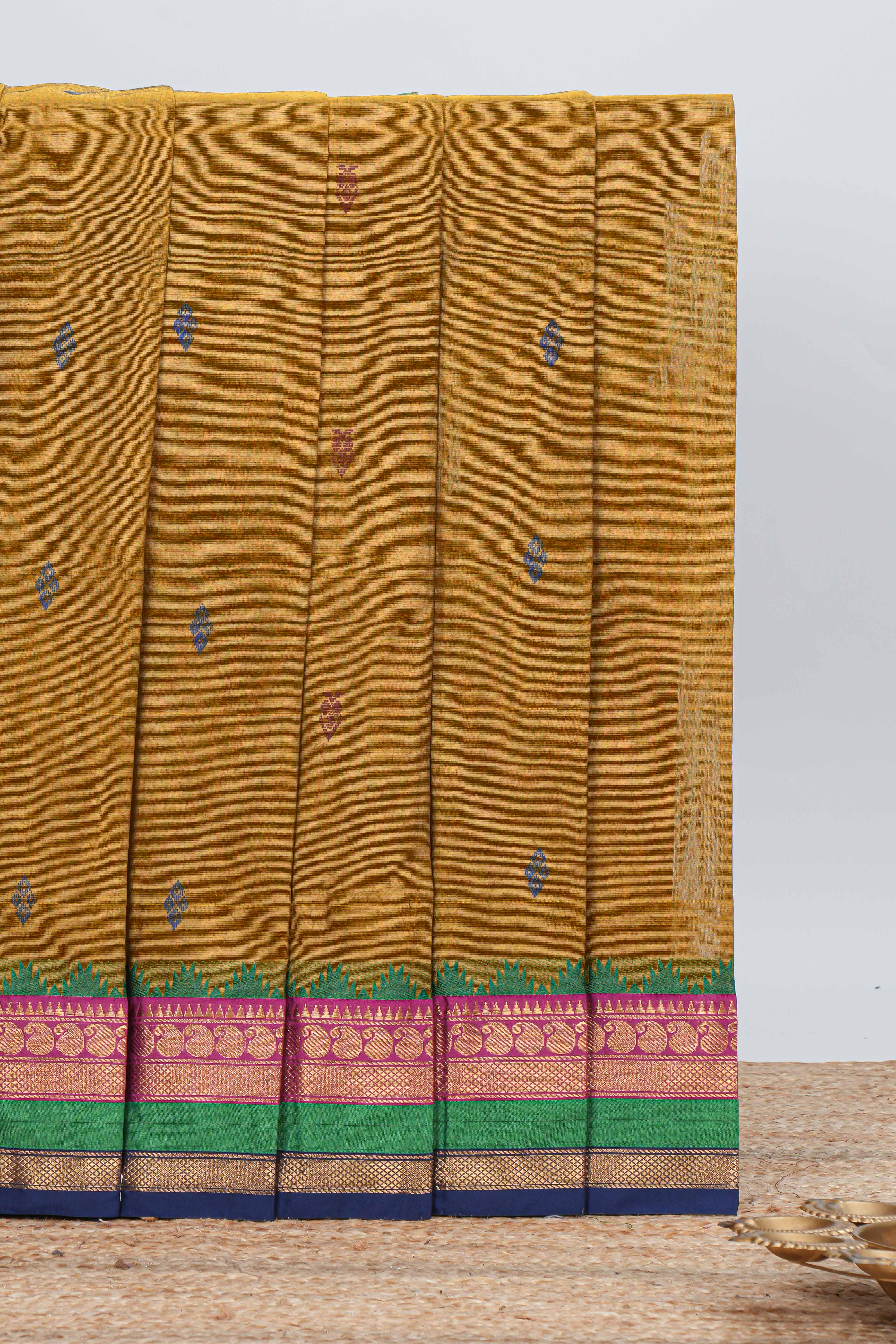 Mustard yellow chettinad cotton saree with all over thread buttas contrast border and matching pallu along with blouse piece