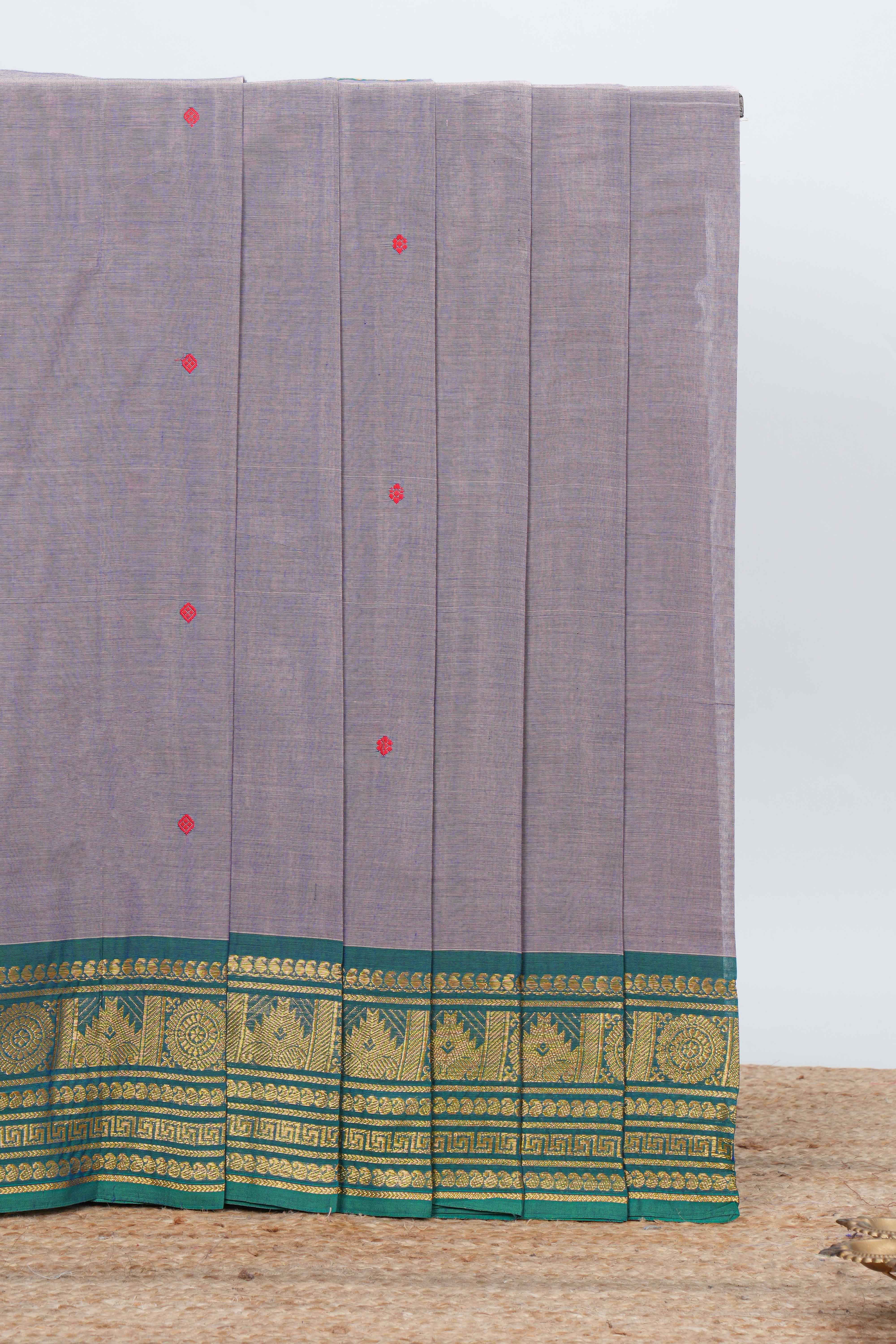 Grey colour chettinad cotton saree all over thread butta with contrast border and matching pallu along with blouse