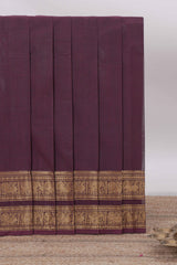 Dark brown Chettinad cotton saree with a plain body antique gold zari elephant retta petta border along with matching blouse