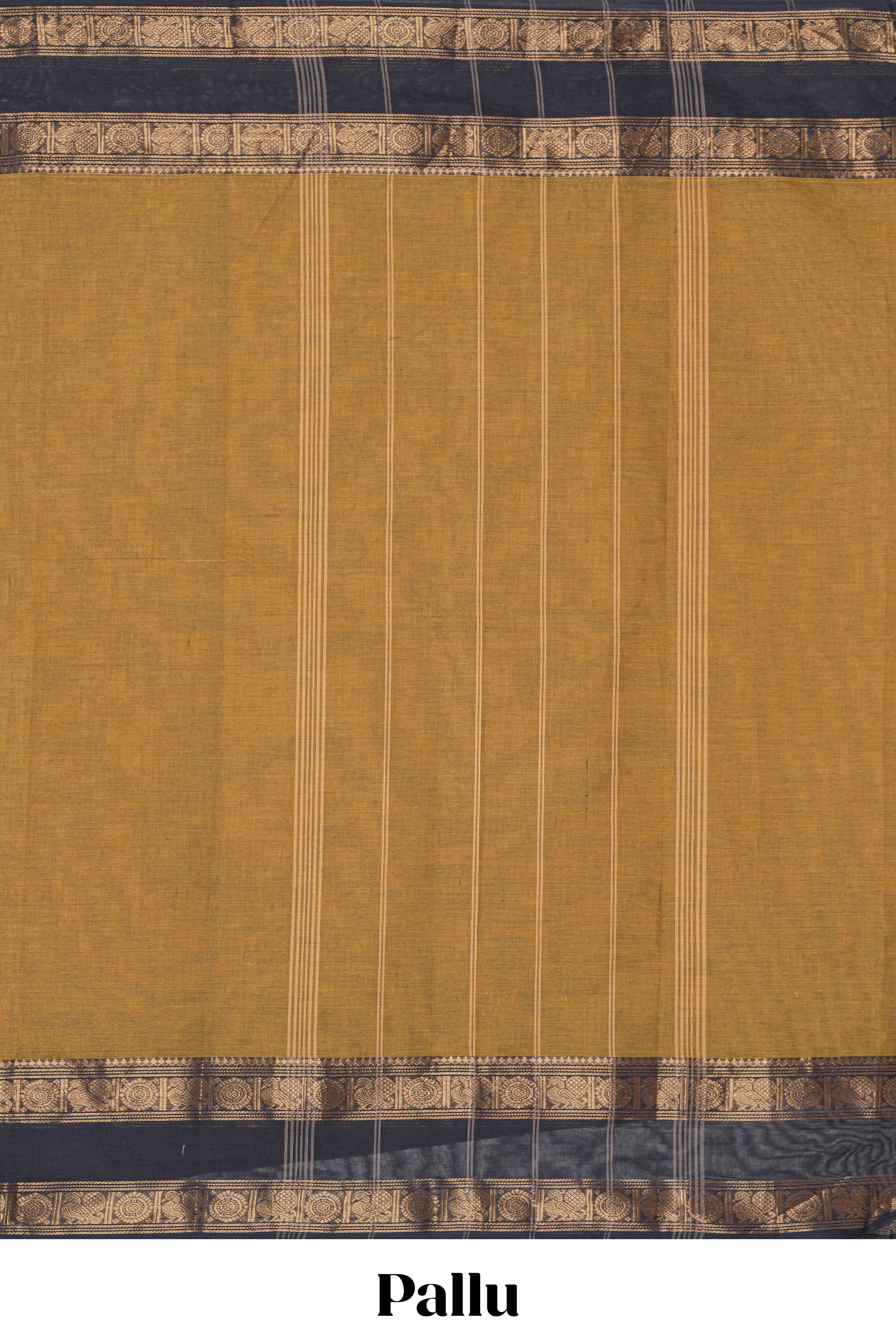 Mustard yellow Chettinad cotton saree with a plain body and a contrasting black border by intricate antique gold zari motifs along with blouse piece
