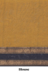 Mustard yellow Chettinad cotton saree with a plain body and a contrasting black border by intricate antique gold zari motifs along with blouse piece