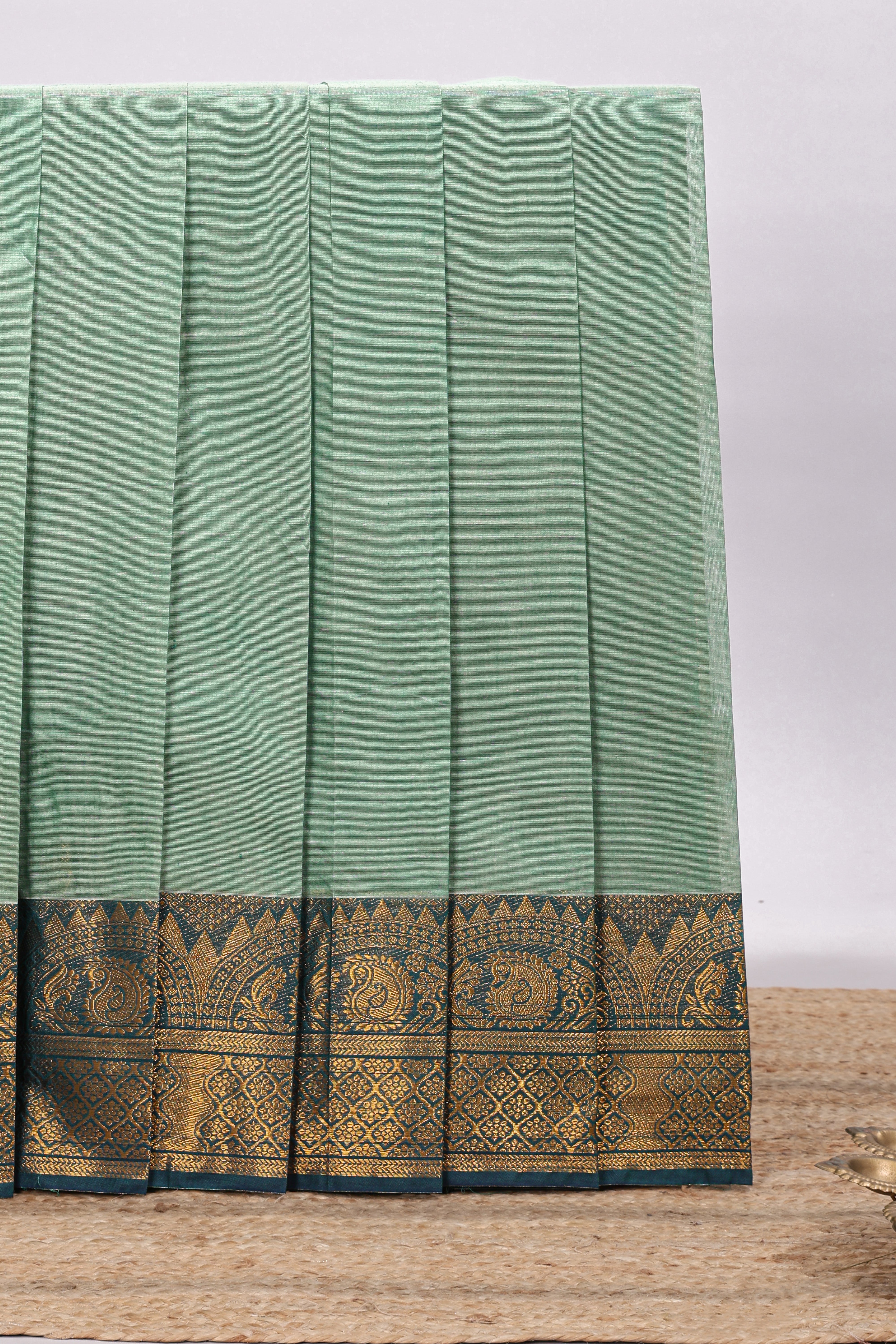 Teal green plain chettinad cotton saree with contrast zari border and matching blouse