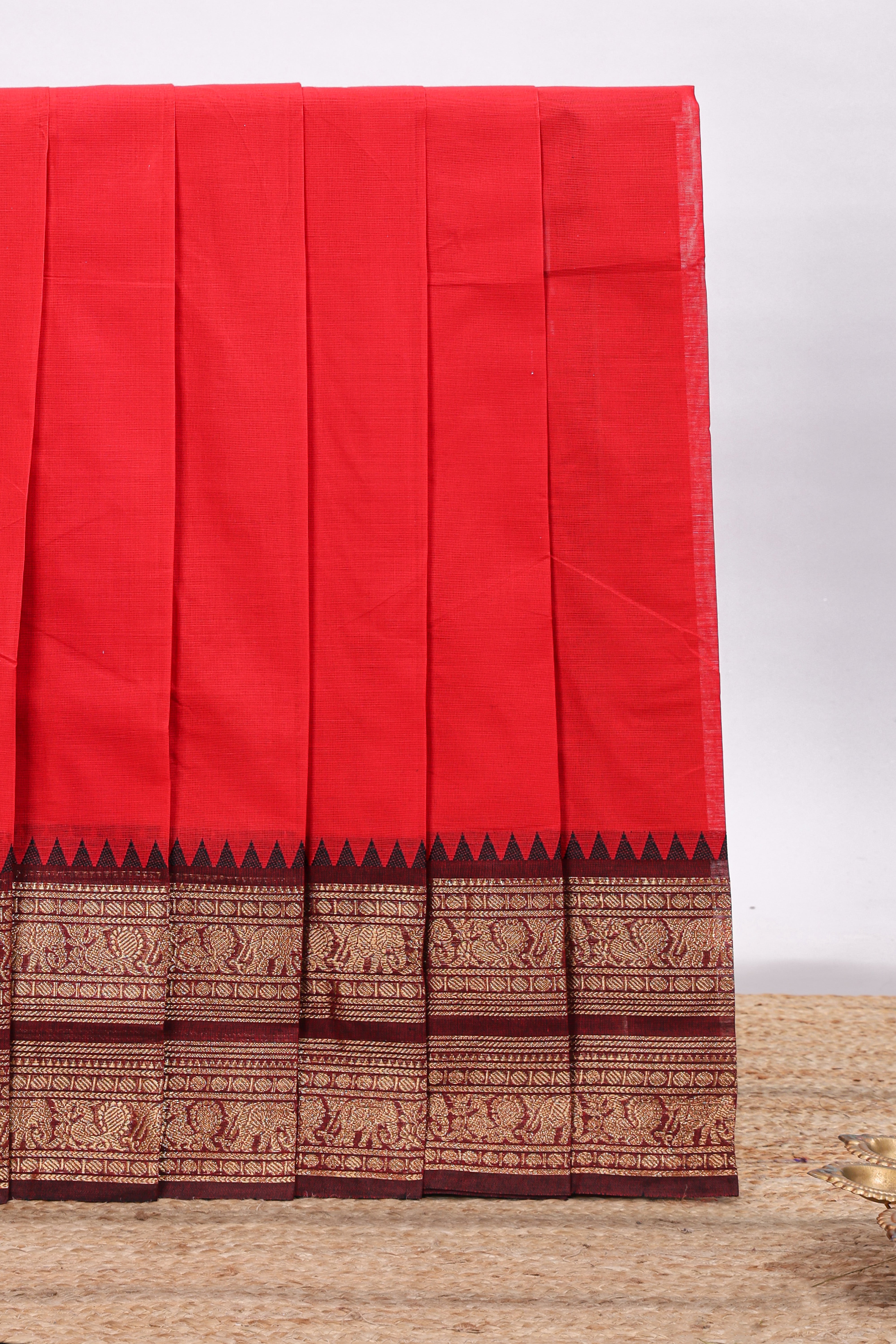 Red plain chettinad cotton saree with contrast zari border and matching blouse
