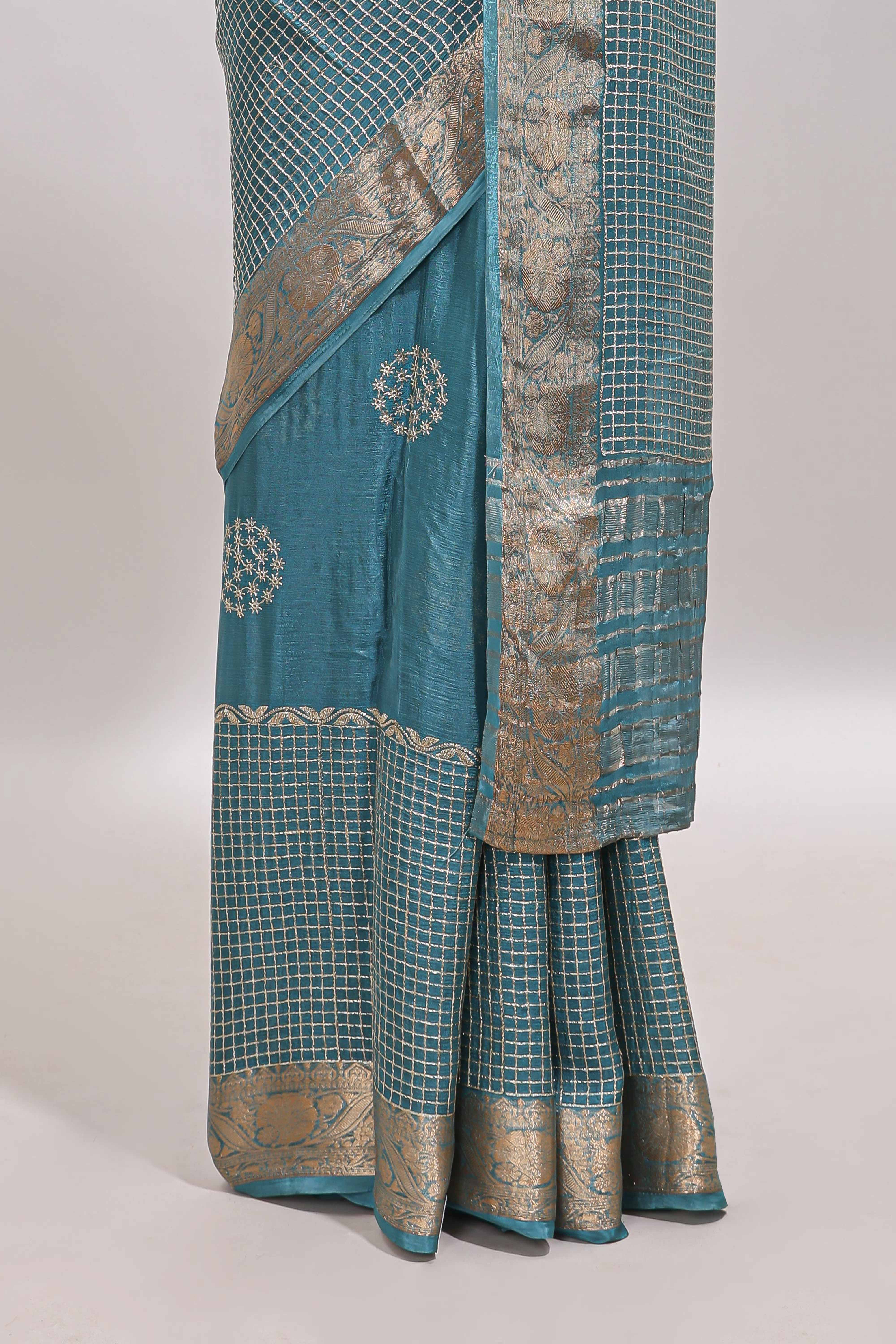 Turquoise blue checked floral motifs chiffon saree with self zari border and contrast blouse